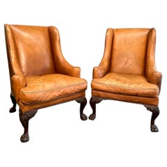 Pair of Vintage Leather and Carved Wood Chippendale Style Wingback Chairs