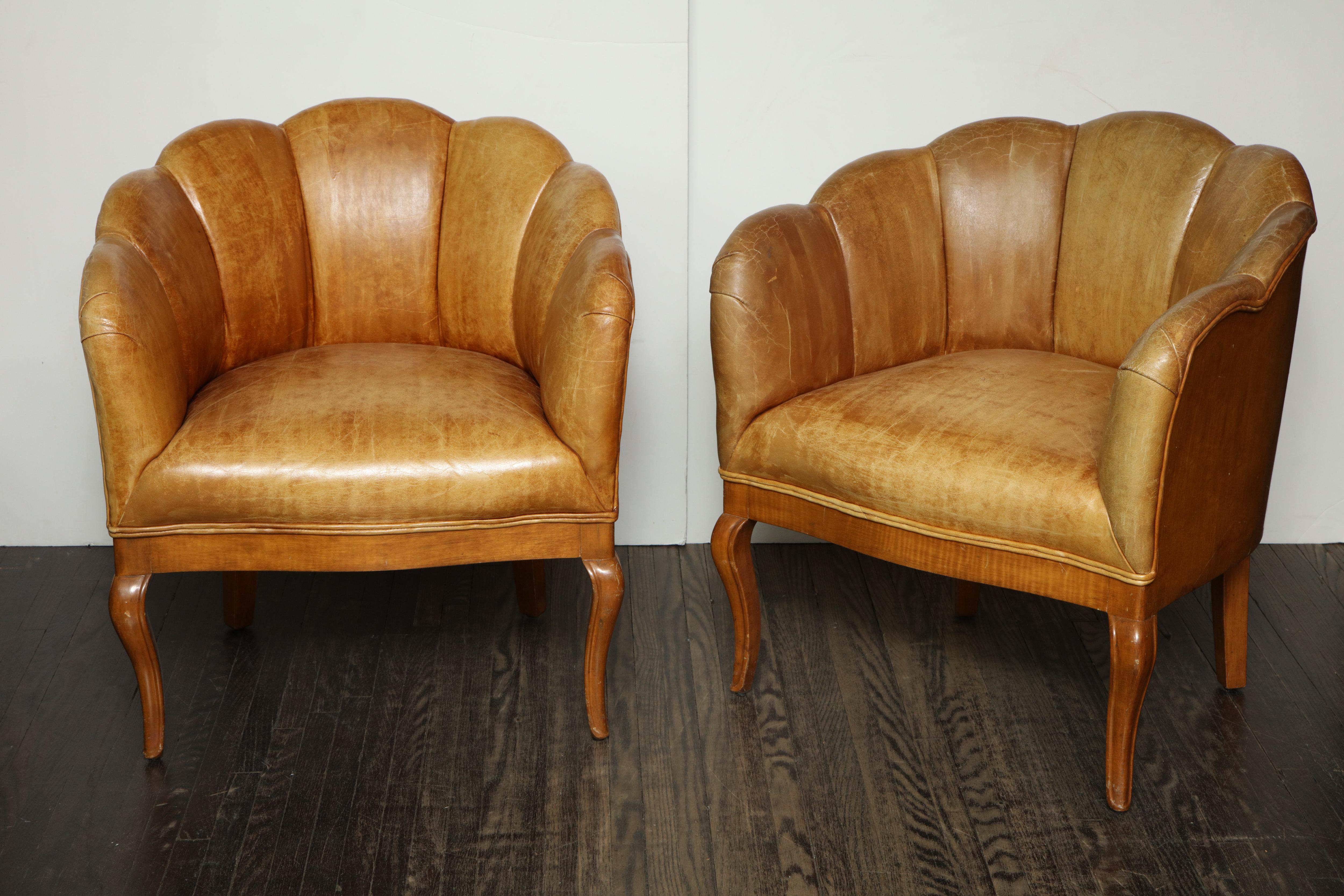 Pair of vintage leather channel back petite chairs.