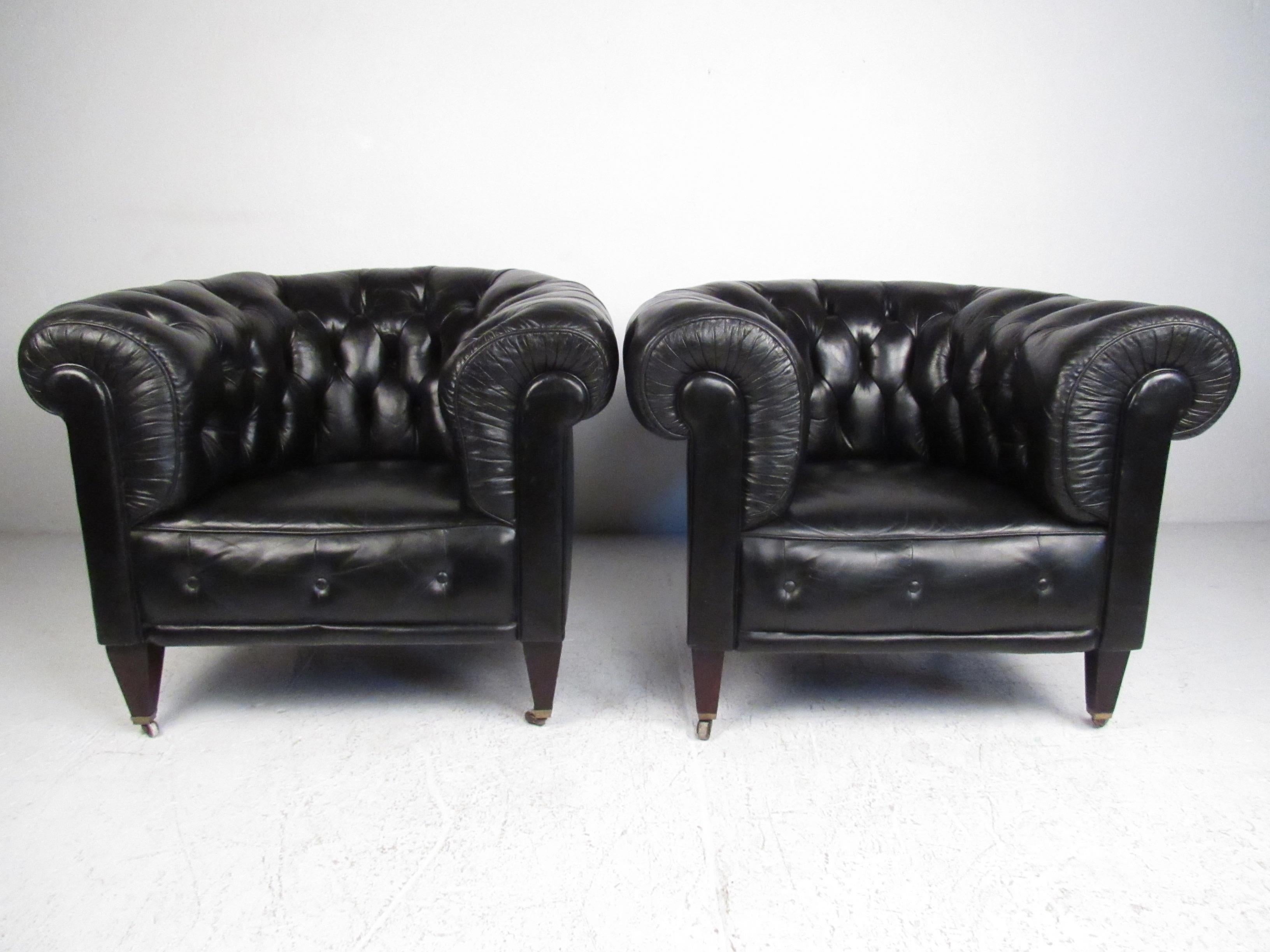 This gorgeous matching set of black leather club chairs make an impressive chesterfield style addition to home or business seating. Generous proportions, thick scrolled arms, and comfortable tufted upholstery add to the vintage charm and timeless