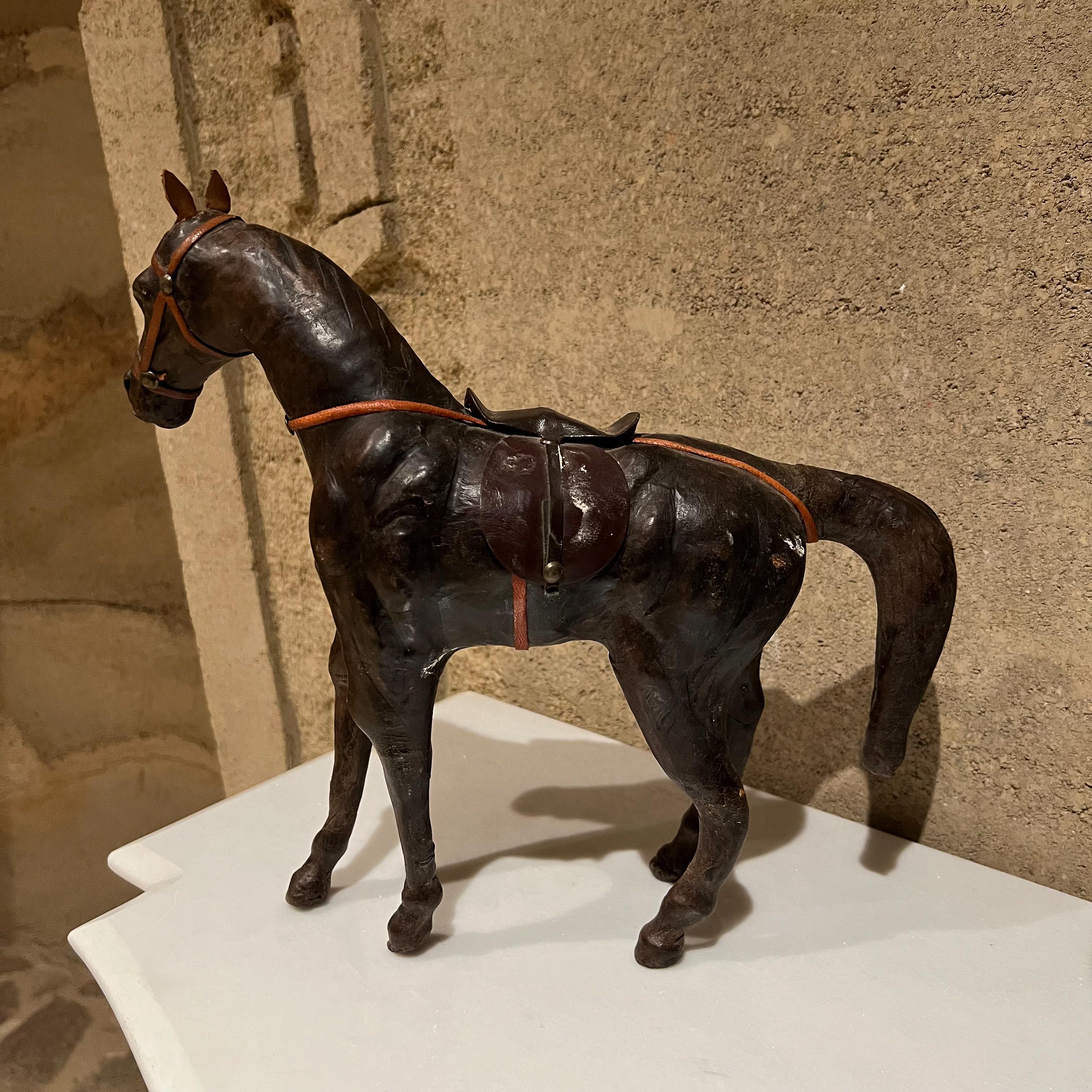 Leather horses
Pair of horse sculptures in leather in the style of Dimitri Omersa for Abercombie & Fitch
Unmarked.
Brown tones
Standing horse: 16 tall x 4 wide x 9.25 deep 
Walking horse: 12 tall x 4 wide x13 deep
Preowned original good