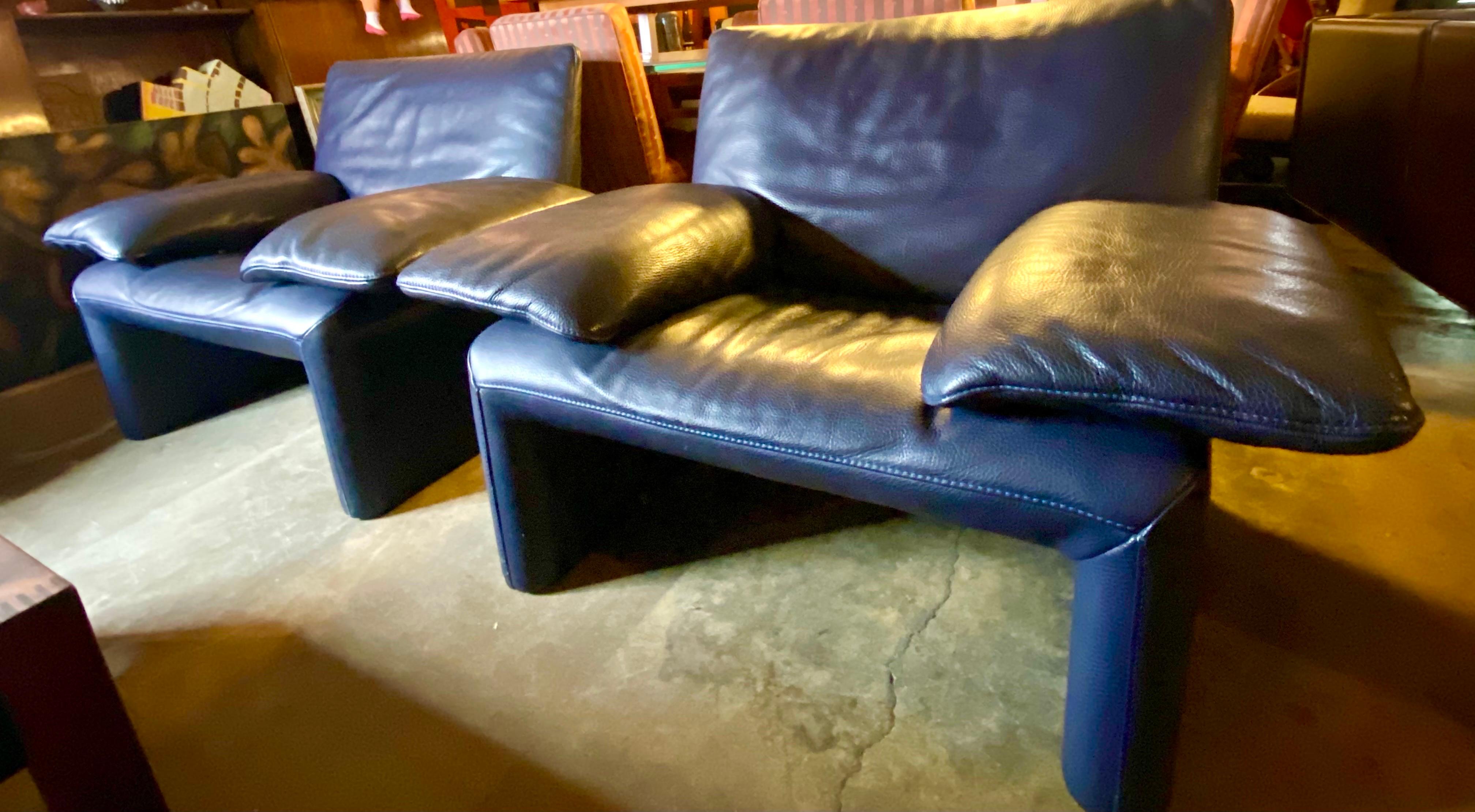 Pair of vintage navy blue leather lounge chairs, Belgium, circa 1990’s features an ergonomic concept with wide, comfortable armrests that can be set in four different positions to offer your head, arms, and back a sense of well-being. The pair of