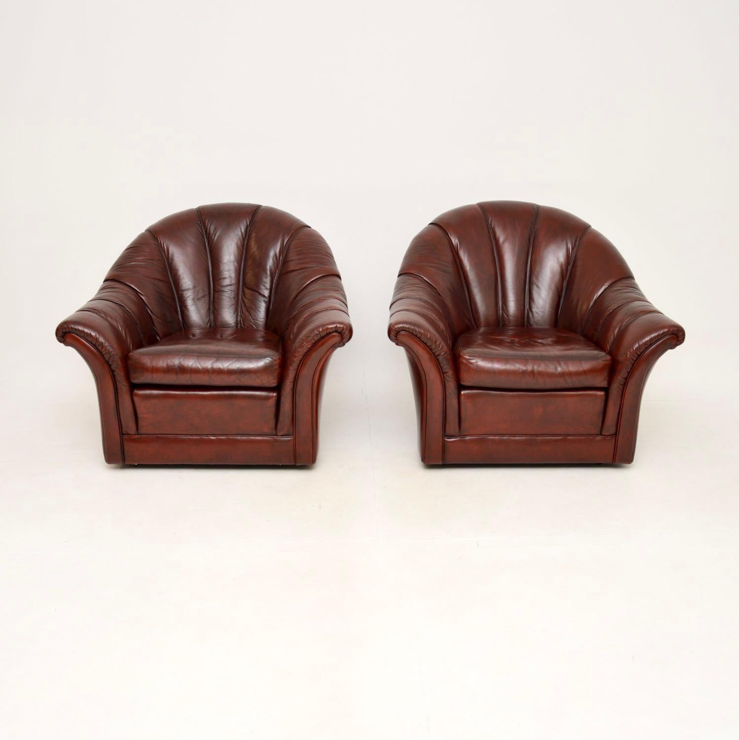 A stylish and extremely comfortable pair of vintage leather scallop back armchairs. They were made in England, they date from around the 1970’s.

The quality is superb, they are very generous and roll smoothly on casters. The scalloped backs give