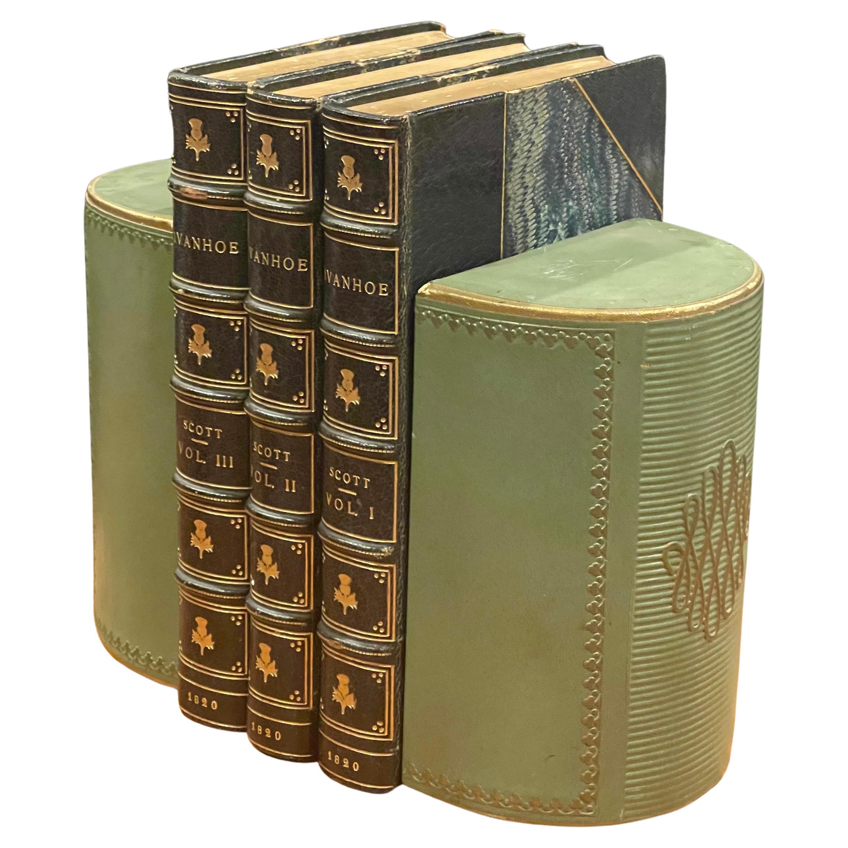 Classic pair of green leather wrapped bookends, circa 1950s. The bookends measure 5.75