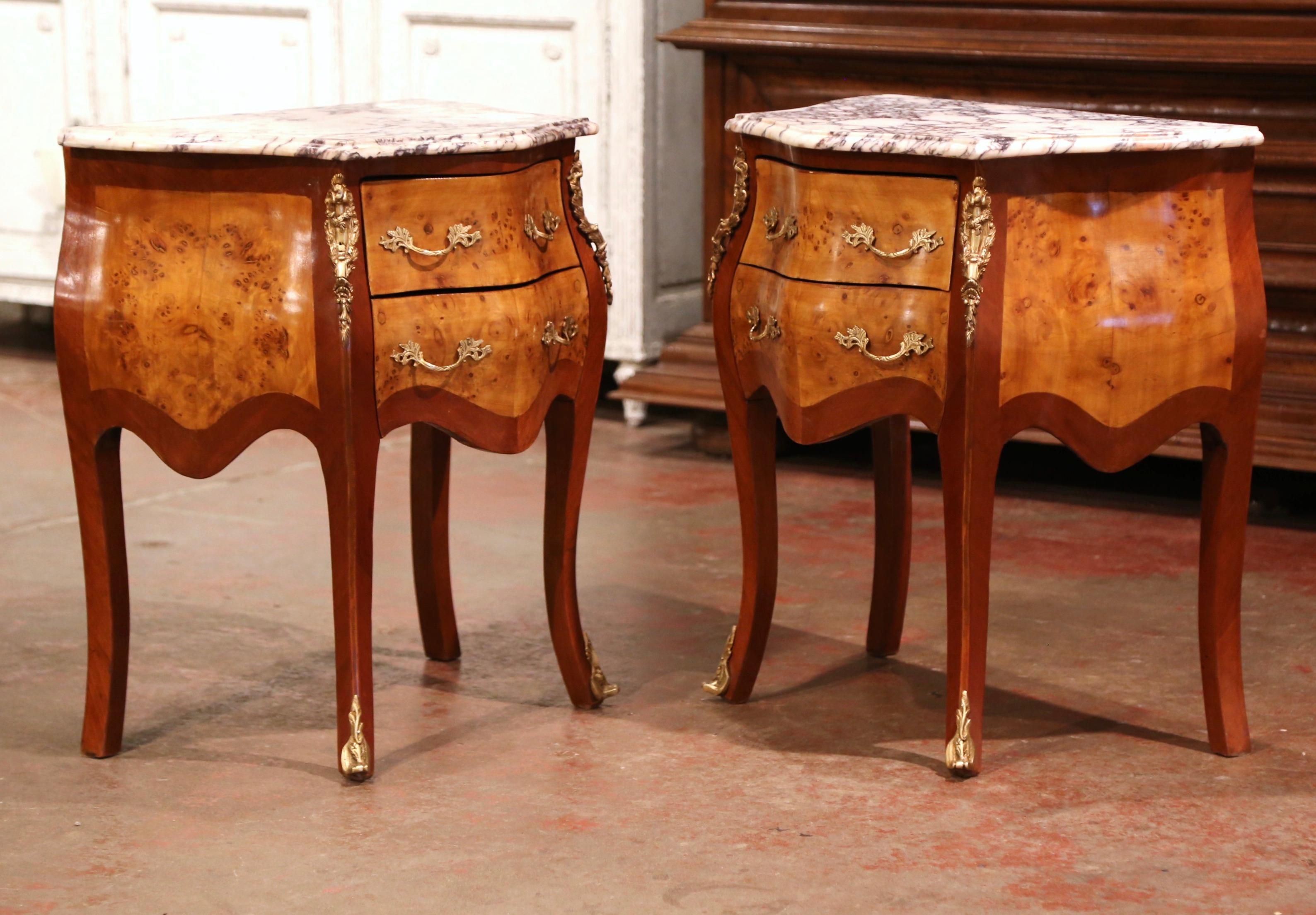 These elegant bedside tables were created in France, circa 1980. Bombe in shape on all three sides, the fruitwood petite chests stand on cabriole legs ending with decorative bronze sabot feet; both sides with serpentine shape have inlaid veneer
