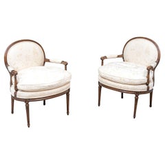 Pair Of Vintage Louis XVI Style Carved And Upholstered Fauteuils