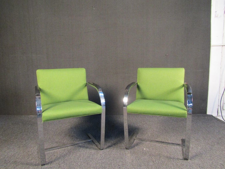 Pair of vintage green lounge chairs with chrome frames and eye-catching fabric upholstery. Chair backs feature a contrasting upholstery with geometric patterns. Please confirm item location with seller (NY/NJ).
