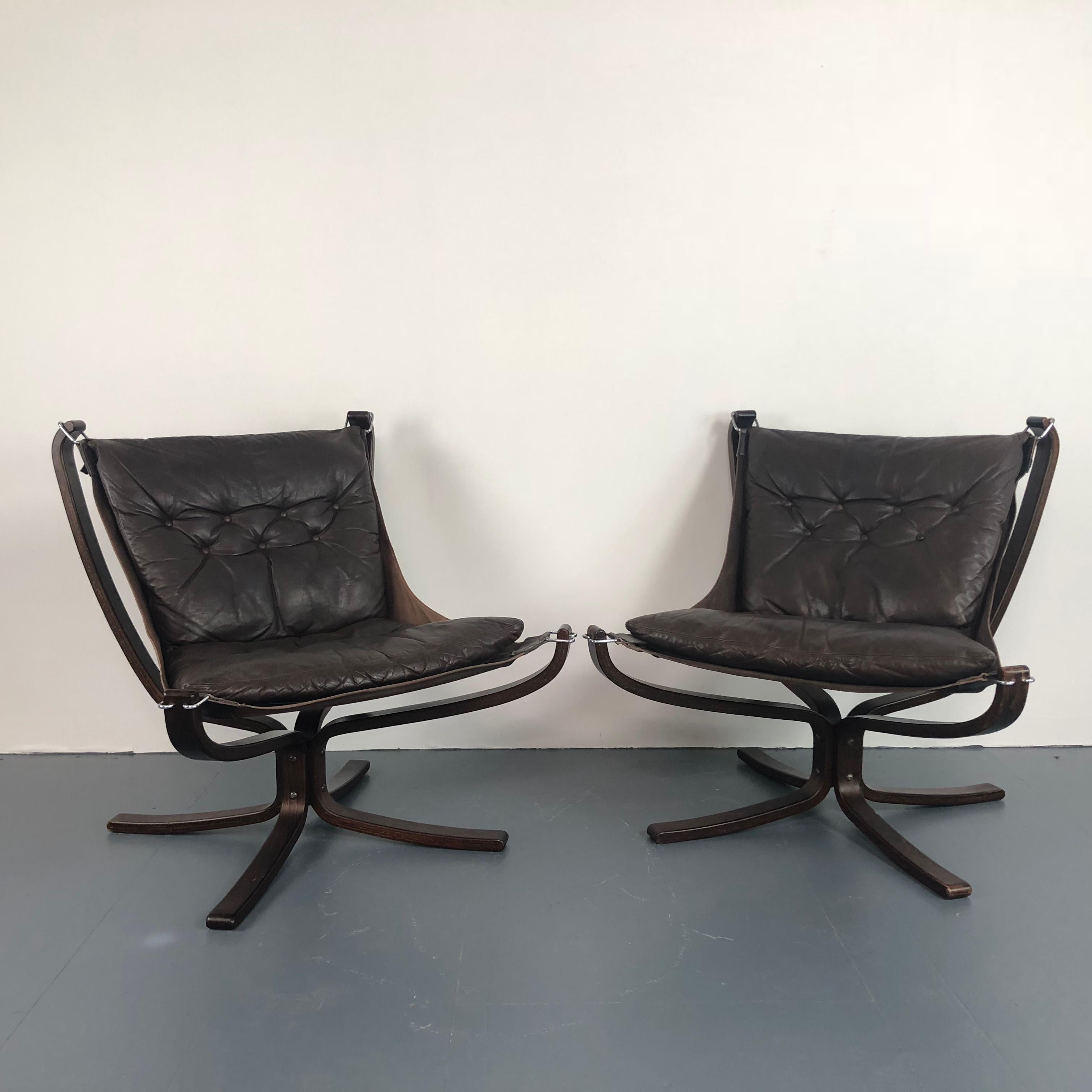Lovely pair of low back dark brown leather Falcon chairs designed by the Norwegian designer, Sigurd Resell, in the 1970s. With rosewood base which is an X shape. 

In good vintage condition. The leather is in good condition for its age with no