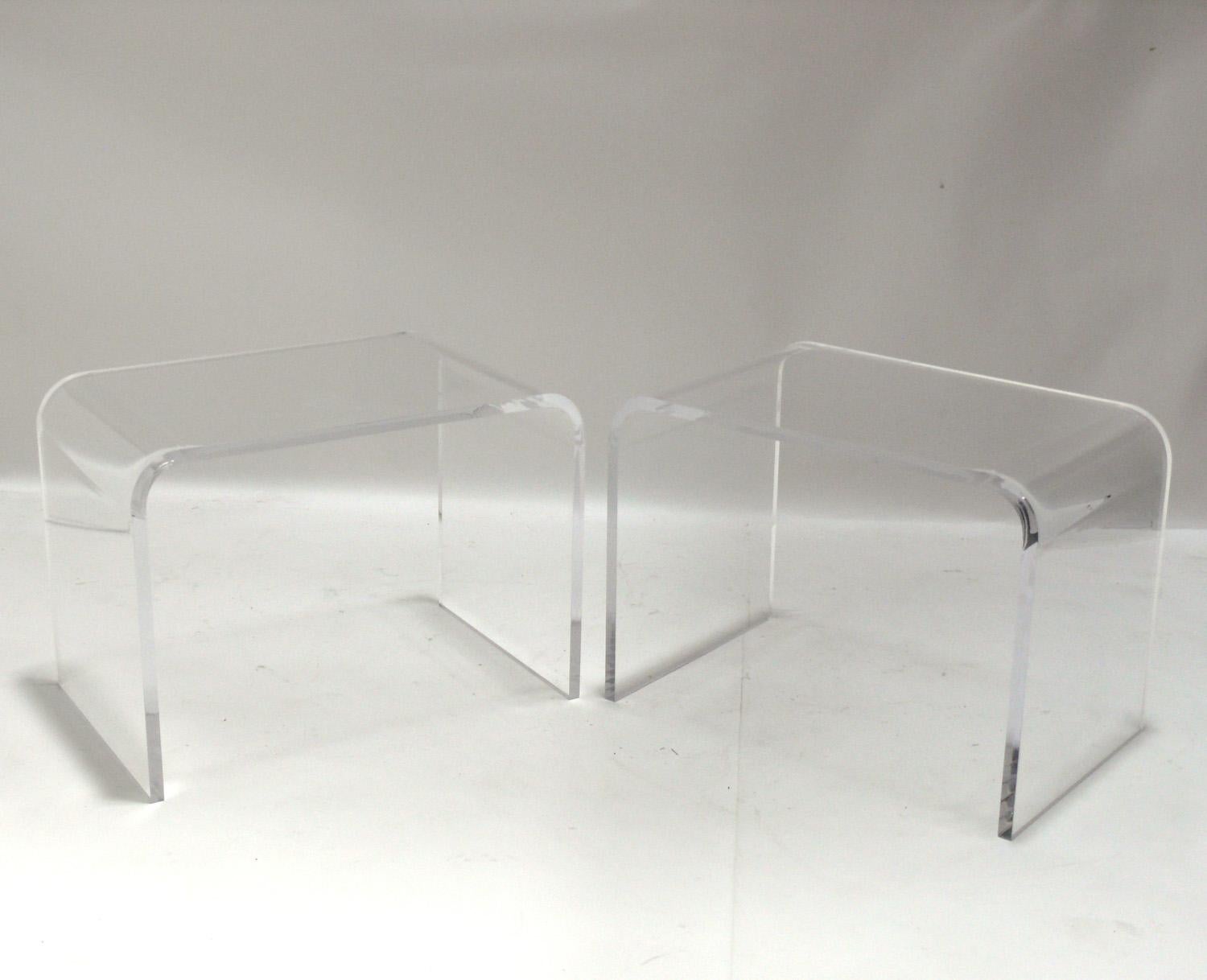 Pair of vintage lucite or acrylic waterfall end tables, American, circa 1970s. High quality heavyweight construction with thick lucite. They are a versatile size and can be used as end or side tables, or as nightstands. They have been cleaned and