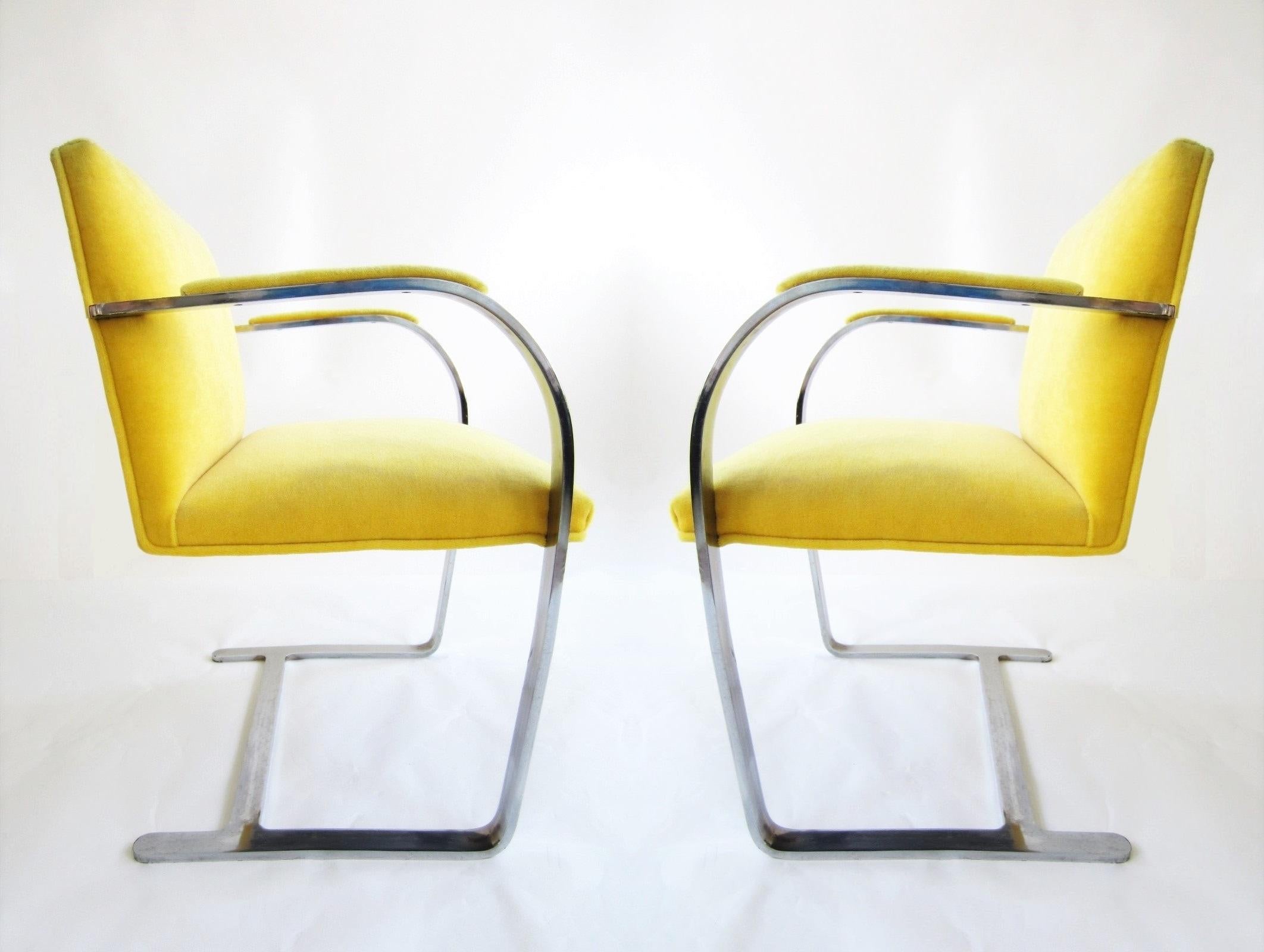 These vintage modern Brno flat bar chairs are sleek and timeless. Chairs feature cantilevered, heavy stainless steel flat-bar frames. The seat, backrest and the arched armrests newly re-upholstered in yellow velvet. Unmarked. Designed for multi-use