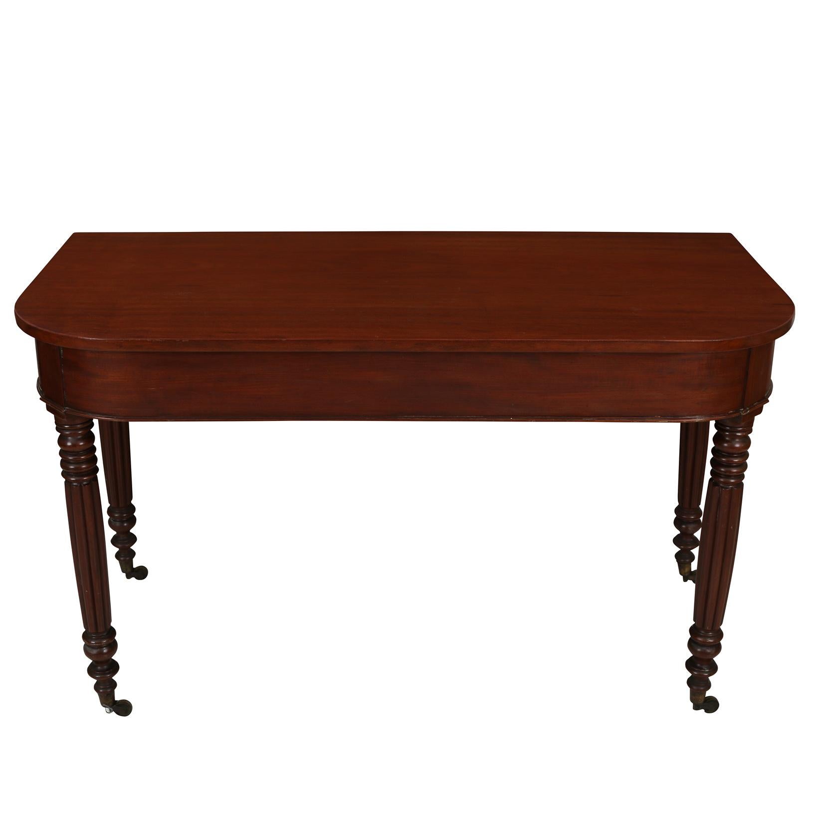A fabulous pair of vintage mahogany demi-lune tables with fluted legs and wheels in great vintage condition, the perfect addition to your home! Would be great in a living room or dining room or entry, this pair was recently touched up and is the