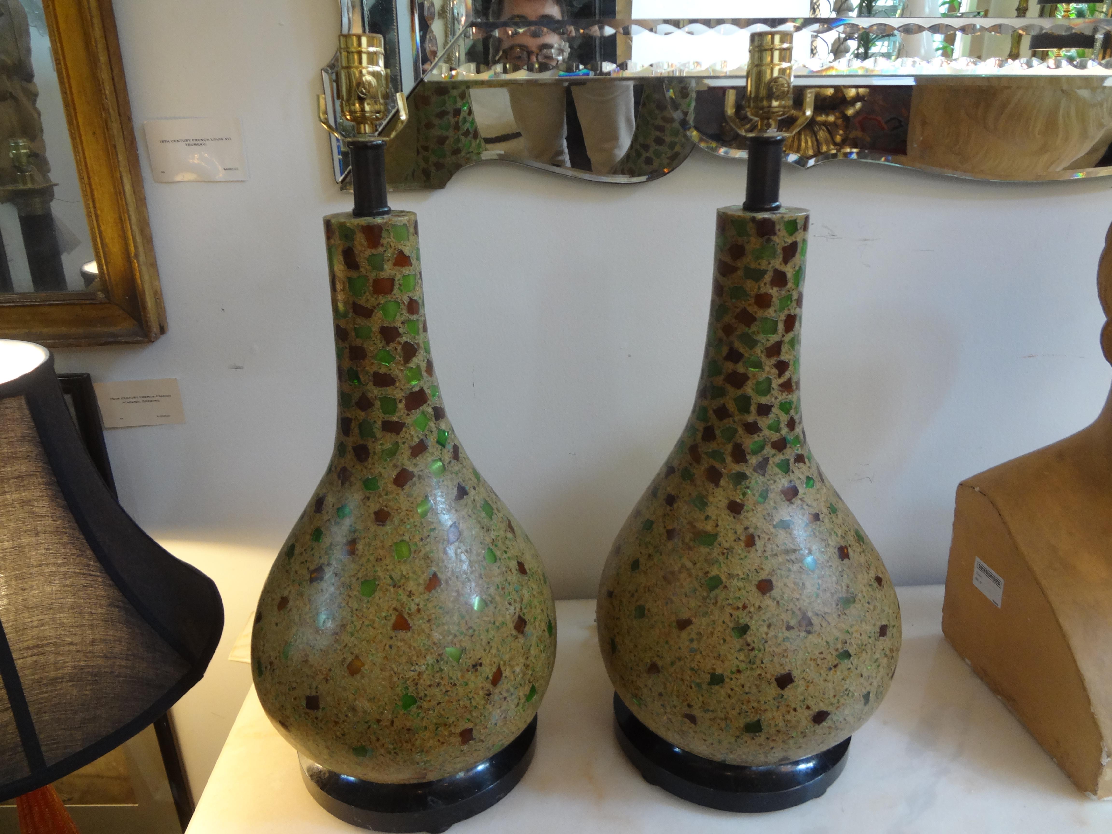 Pair of vintage Maitland Smith lamps on Tessellated stone bases.
Unusual large pair of Hollywood Regency Maitland Smith table lamps. These stunning lamps are gourd shaped with inlaid green and amber colored resin resting on tessellated stone bases.
