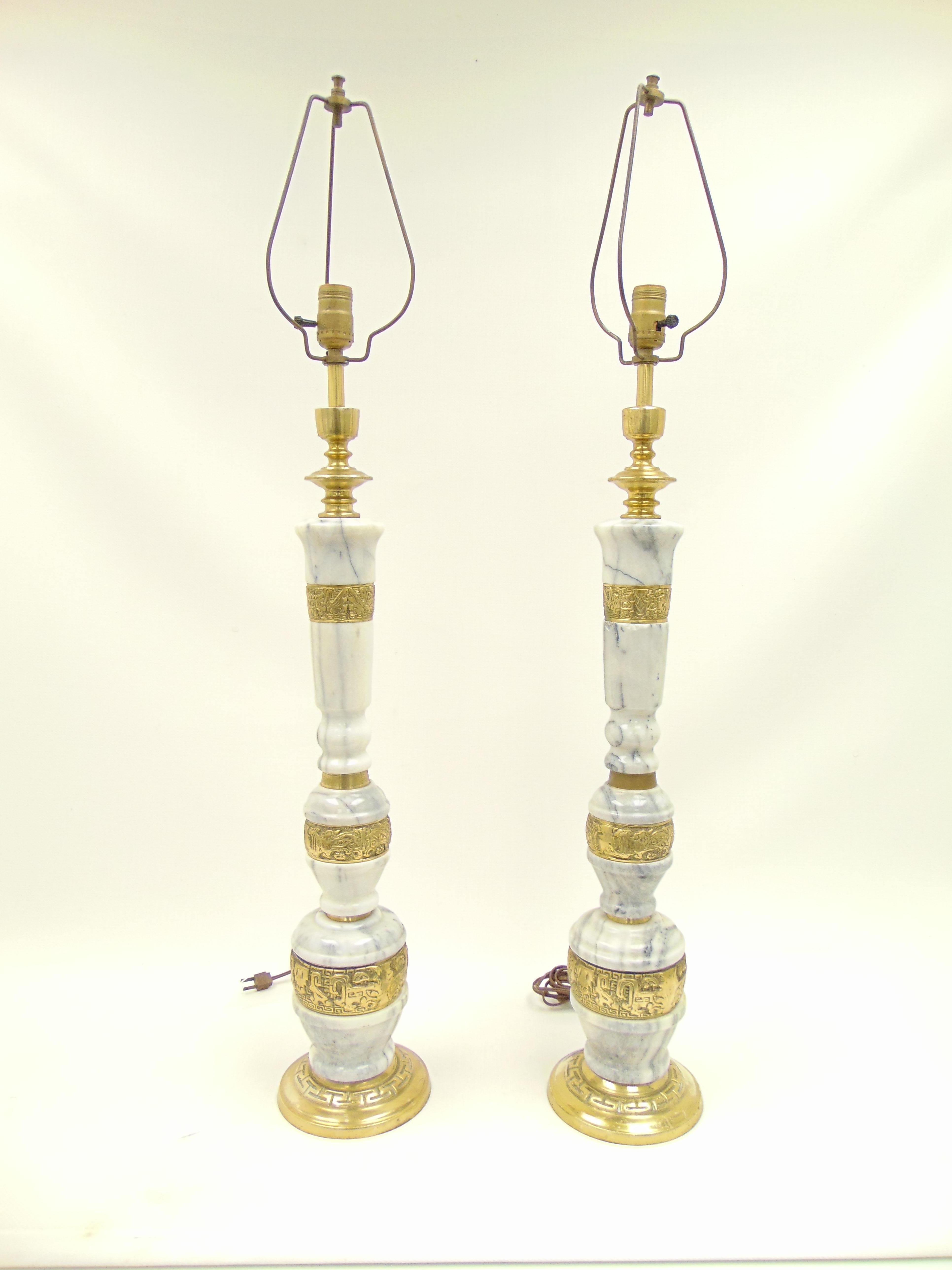Beautiful pair of vintage rare lamps made of marble and brass with detailed designs in the brass. The dimensions are: 39” total height, 32” height to bulb, 6.25” diameter of base.