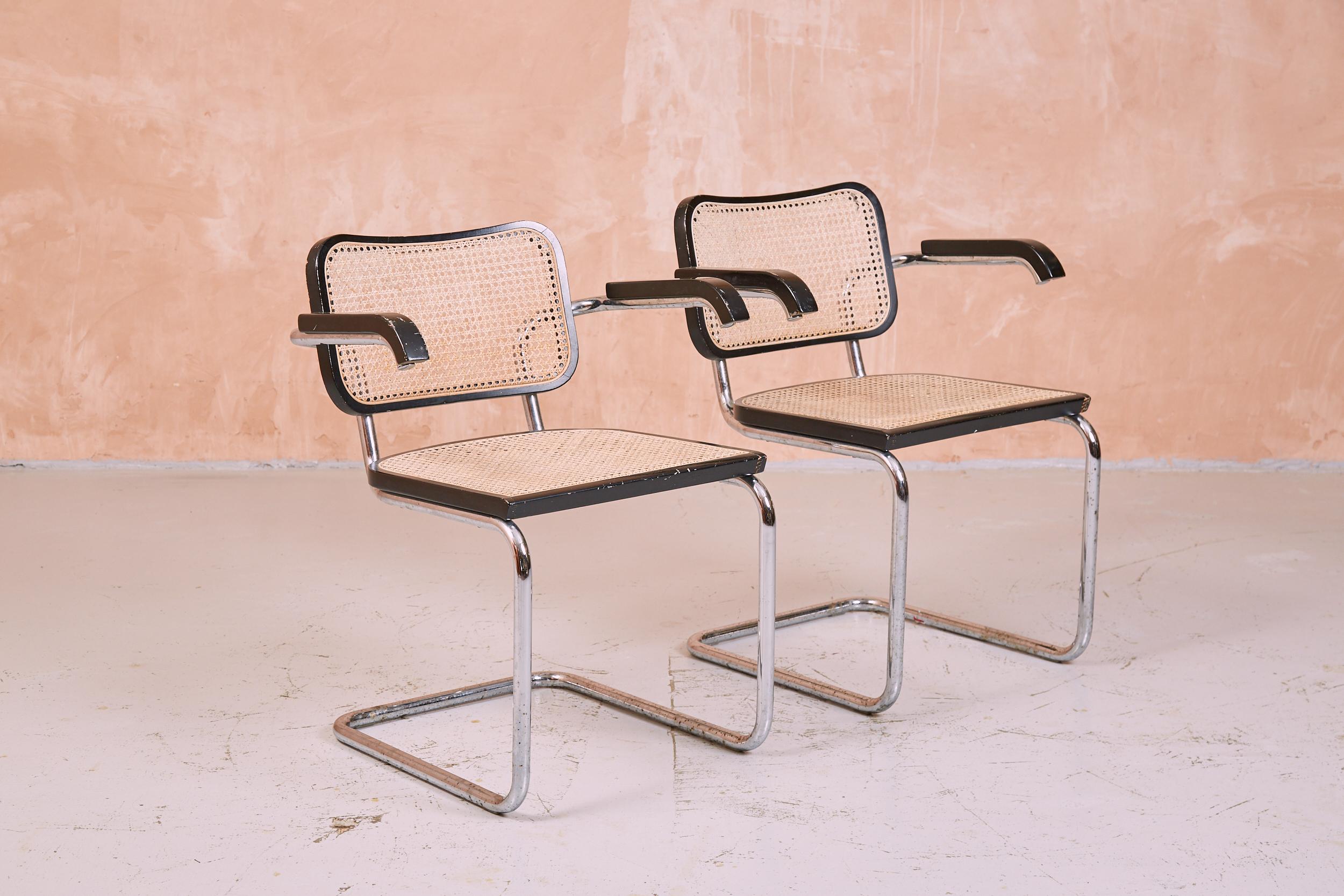 Pair of vintage square back Marcel Breuer Cesca carver chairs with characterful patina to the frames. Perfect to complete a dining set or use as desk or lounge chairs.