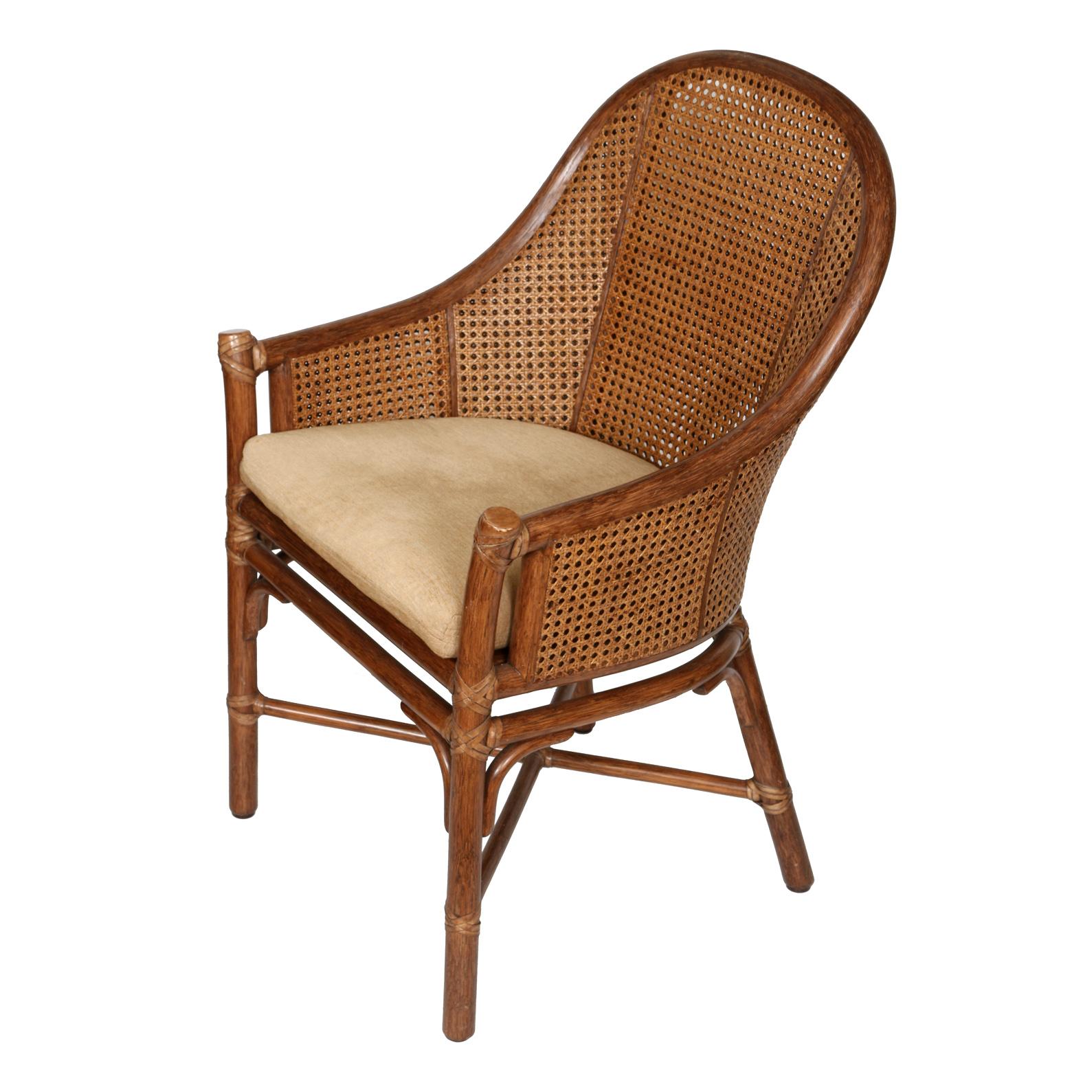 Pair of vintage McGuire bamboo bucket chairs with caned back and sides and cushioned seat.