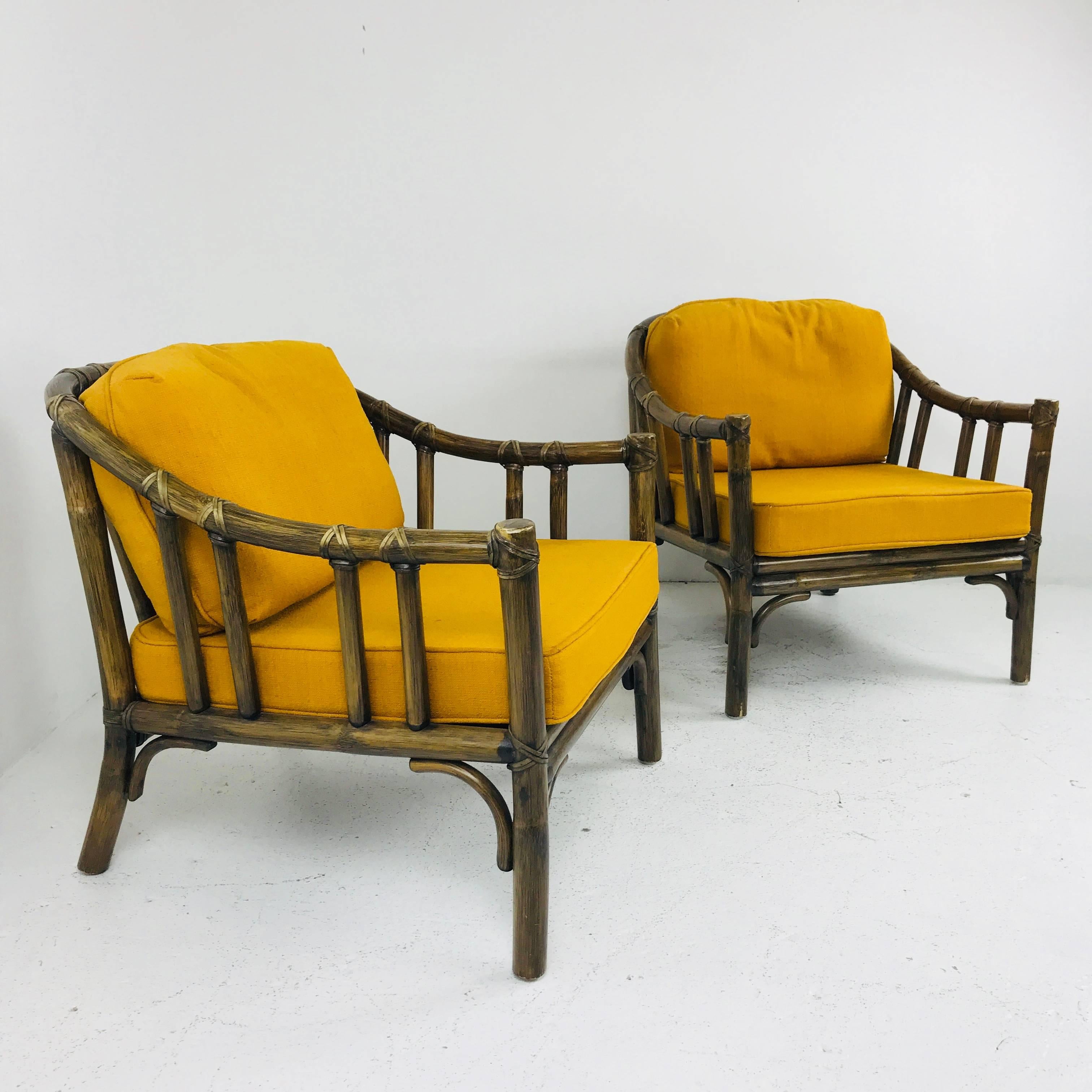 Pair of vintage McGuire lounge chairs. Chairs are in nice vintage condition with wear due to age and use. Chairs can be used as is but new finish and upholstery are recommended.

Dimensions: 28