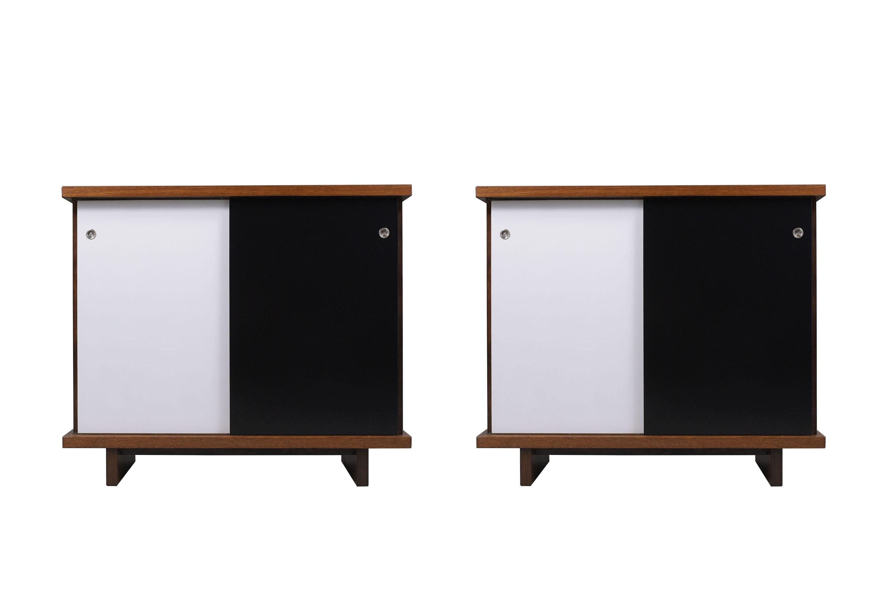 An extraordinary pair of 1960's mid-century American of Martinsville cabinets hand-crafted out of wood are in great condition and have been fully restored by our professional craftsmen team in the house. These pieces feature a walnut white and black