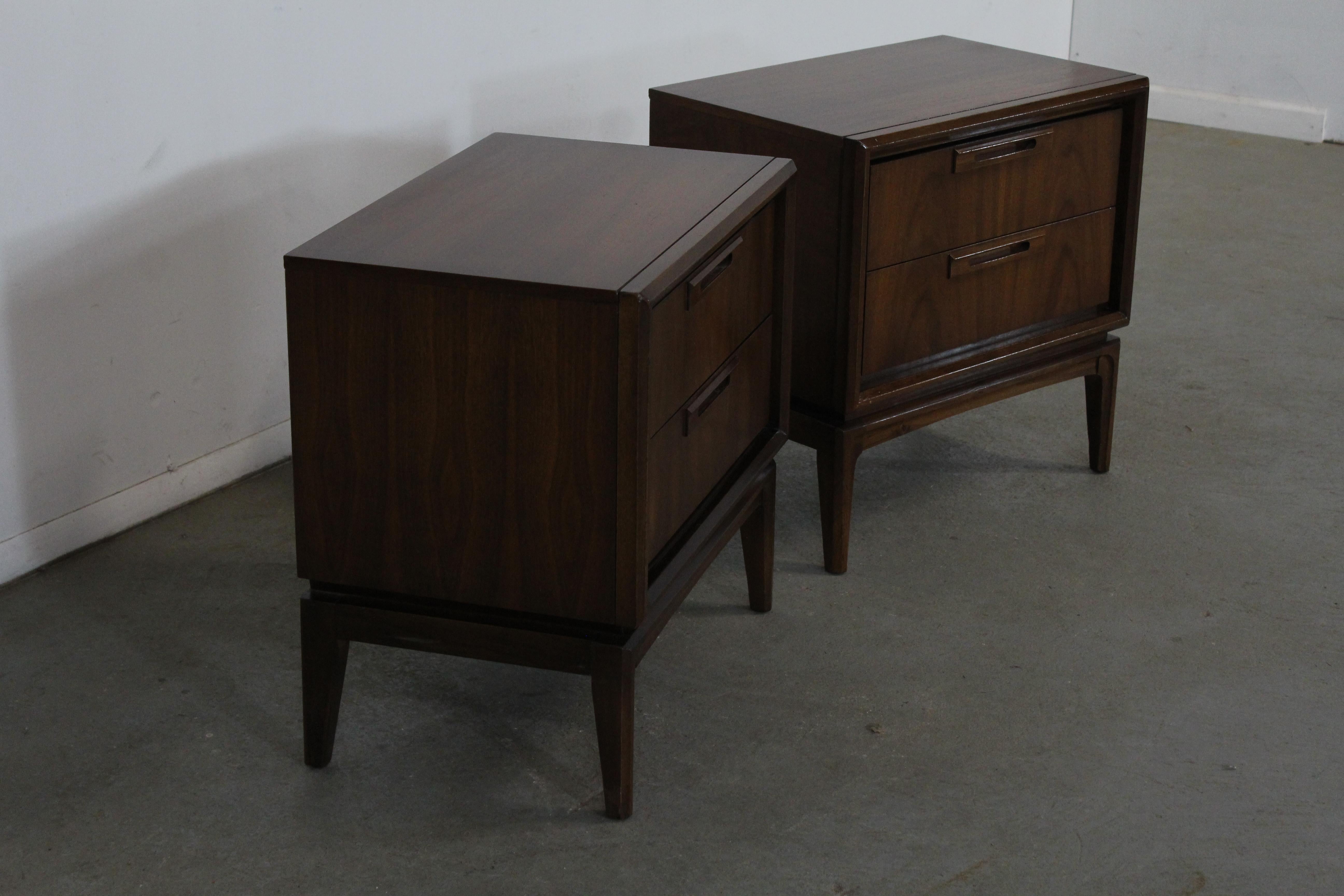 Pair of Vintage mid-century Danish modern walnut nightstands.
Offered is a pair of Mid-Century Modern nightstands. These stands feature a beautiful Walnut face, two drawers each, and on elevated legs. They have been refinished with a walnut stain.