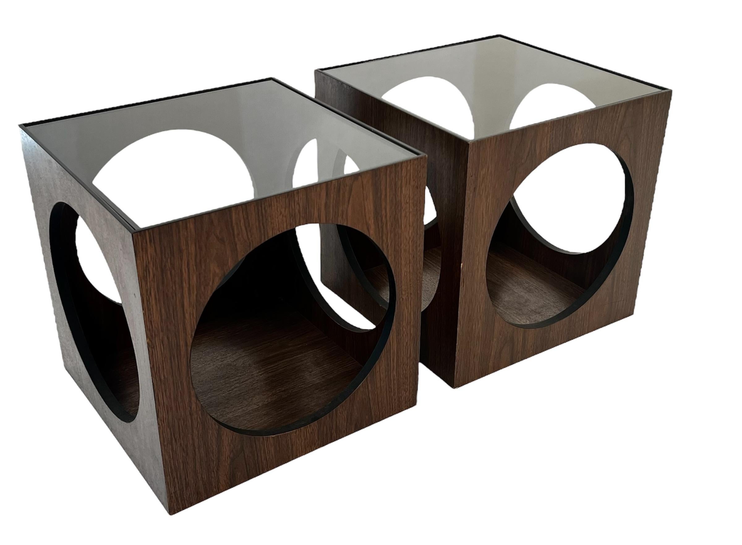 A fantastic pair of Vintage Mid Century Lane Smoked Glass Cube End Tables.  Cube in shape with circle cut outs on each side.  Smoked glass on top compliments the walnut finish.  Each table measures approximately 15 5/8