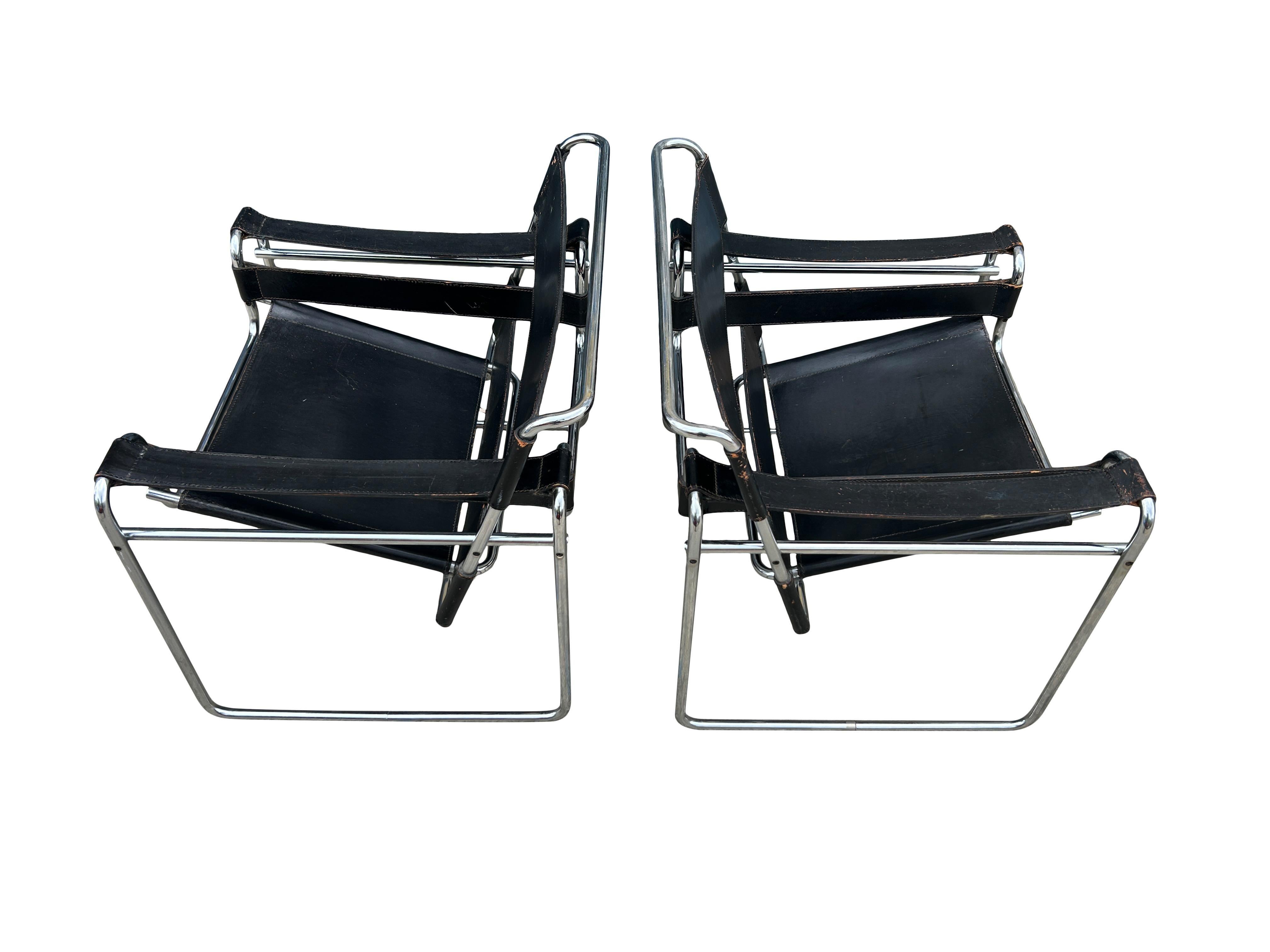 Pair of Vintage Mid-Century Modern Black leather wassily lounge chairs for Knoll. The Wassily lounge chair was designed by Marcel Breuer in Black full leather. Has flat caps on the end tubes, black hex screws, and thick cowhide leather. Marcel