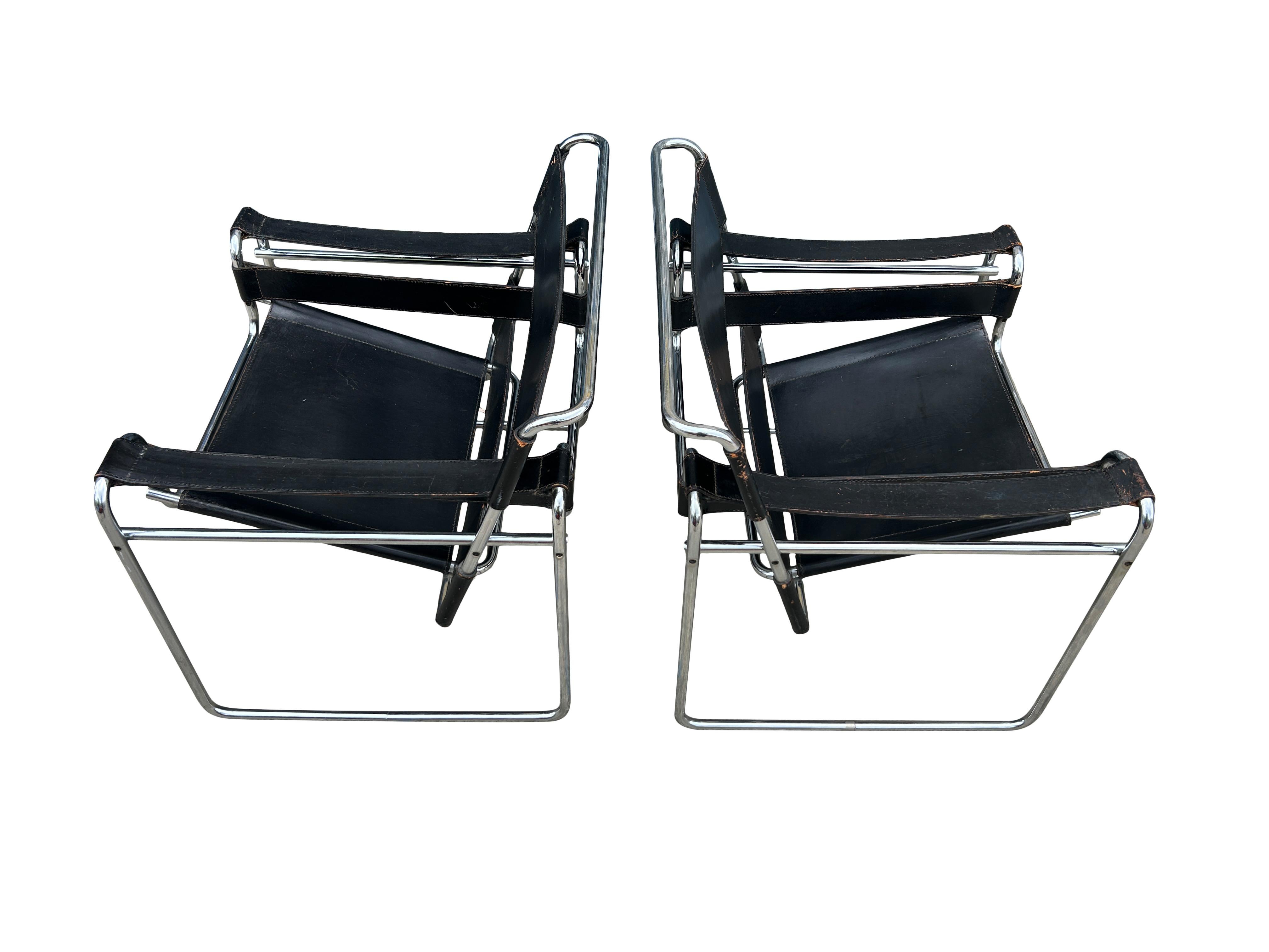 Pair of Vintage Mid-Century Modern Black leather wassily lounge chairs for Knoll. The Wassily lounge chair was designed by Marcel Breuer in Balck full leather. This vintage Pair has paperwork to verify authenticity. also has flat caps on the end