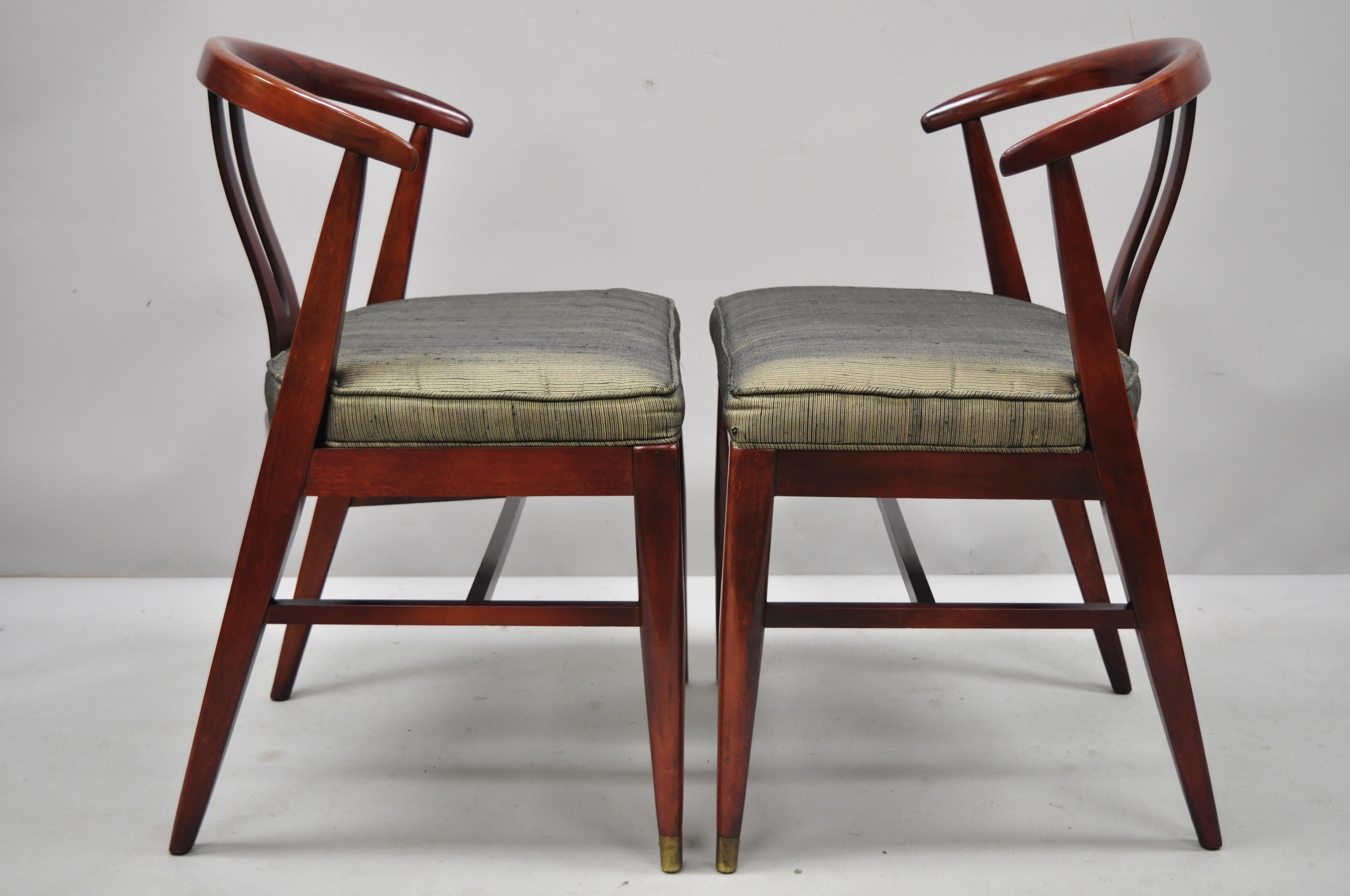 Pair of vintage Mid-Century Modern horseshoe curved back mahogany dining chairs.
Listing includes unique finger joinery, sleek curved back, circa mid-20th century. Measurements: 31.5