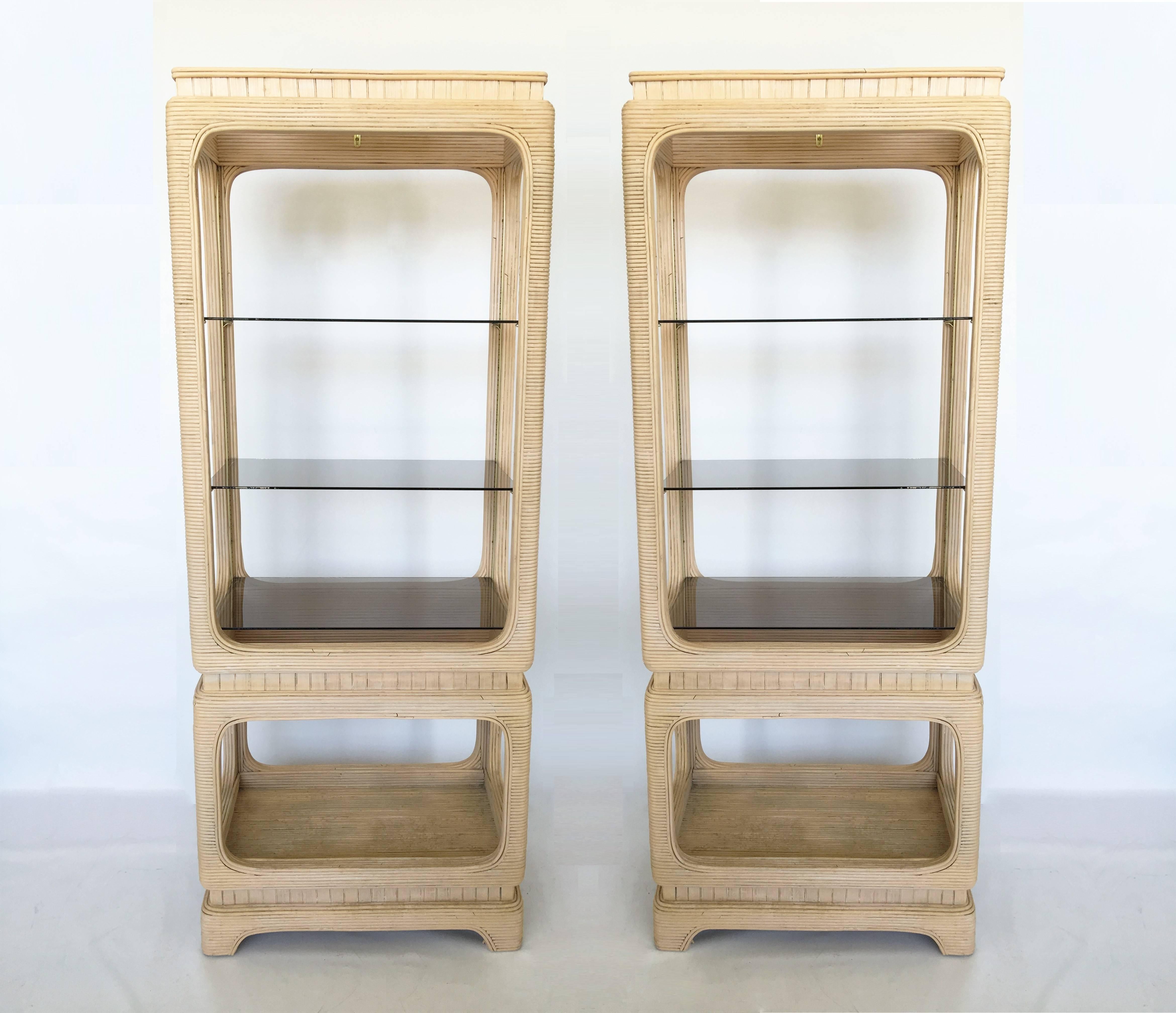 These are rare and extremely hard to find in pairs. A unique design is set with straight lines against gently formed curves at rounded corners. Pencil reed bamboo rattan is applied over a hardwood frame constructed with a cube like shape. The