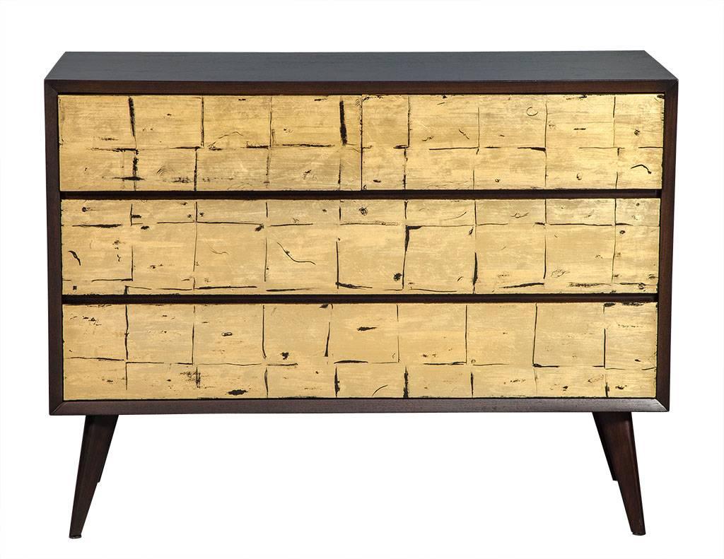 Pair of Vintage Mid-Century Modern Walnut Gold Leafed Chests of Drawers. This sleek Mid-Century American made design is finished in a rich espresso walnut satin, with Carrocel Custom distressed gold leaf and black drawer panels. Topped off with