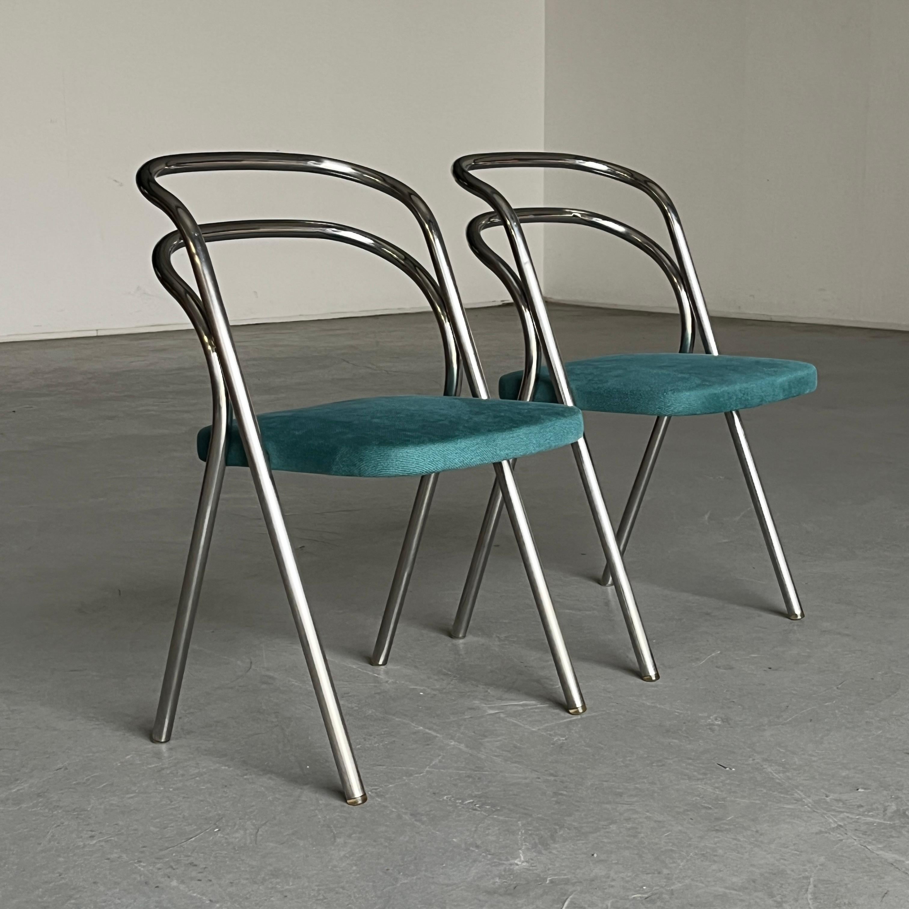 Pair of vintage ‘Santina’ dining chairs designed by Carlo Santi for Zanotta in the 1970s. The seats, which are reupholstered in turquoise fabric, sit on a chromed steel frame with translucent floor stops.

In good vintage condition with smaller