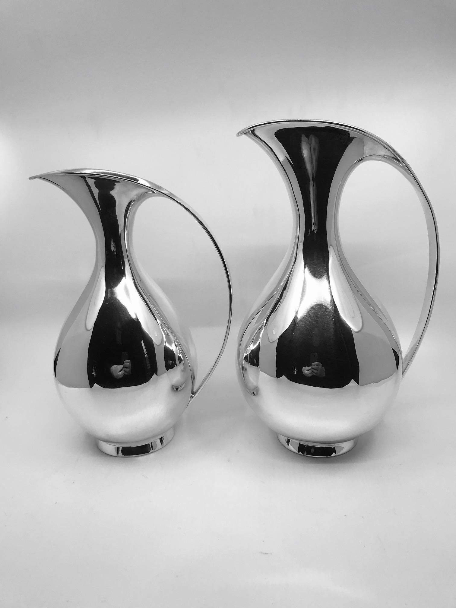 This is a pair of A. Michelsen sterling silver pitchers designed by Kay Fisker in 1935, from a private estate in London. Fisker designed two sizes of this pitcher, both are represented here and sold together. This design has been at the forefront