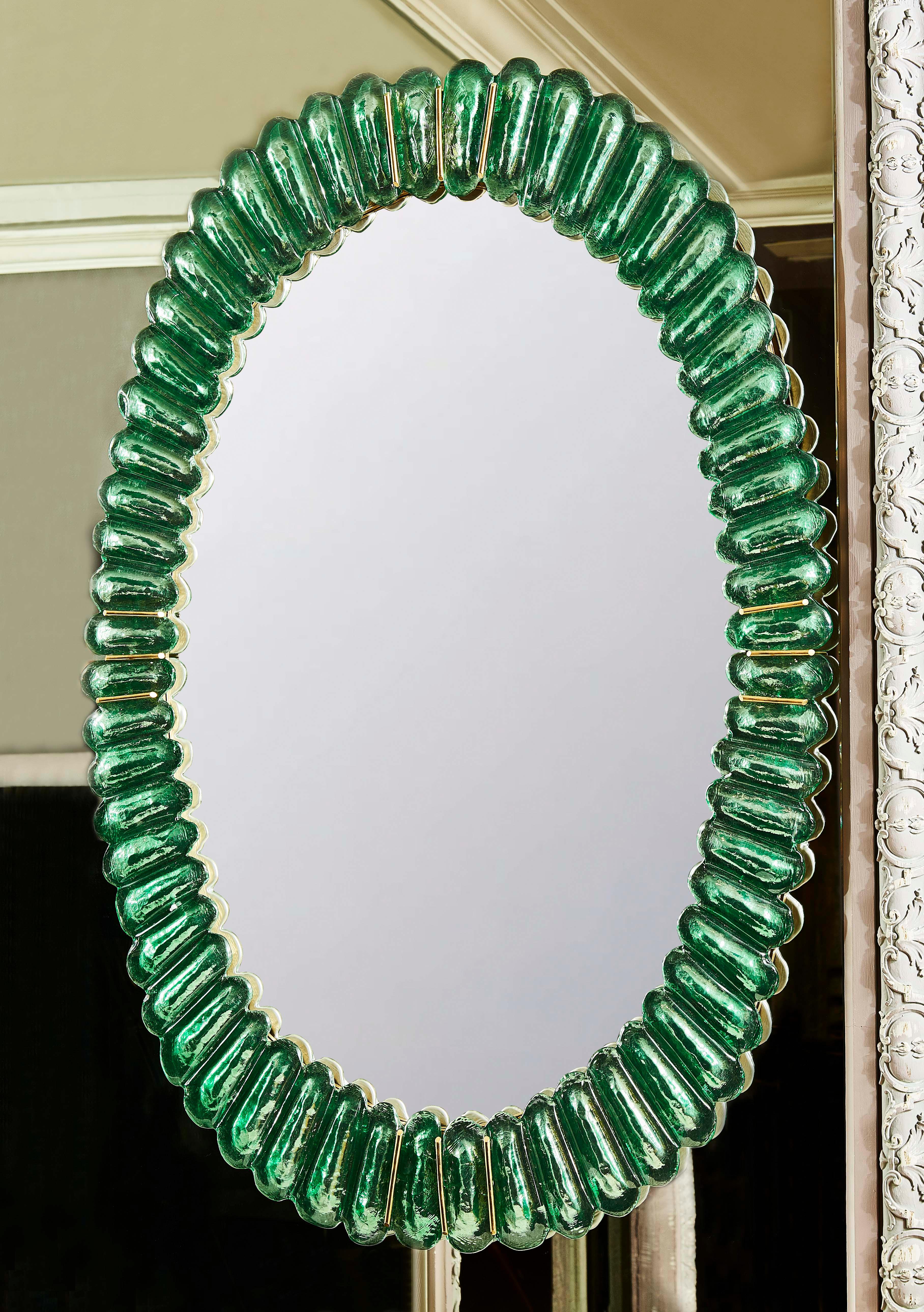 Pair of vintage oval mirrors made of green Murano glass and brass inlays. 
Italy, 1970s.