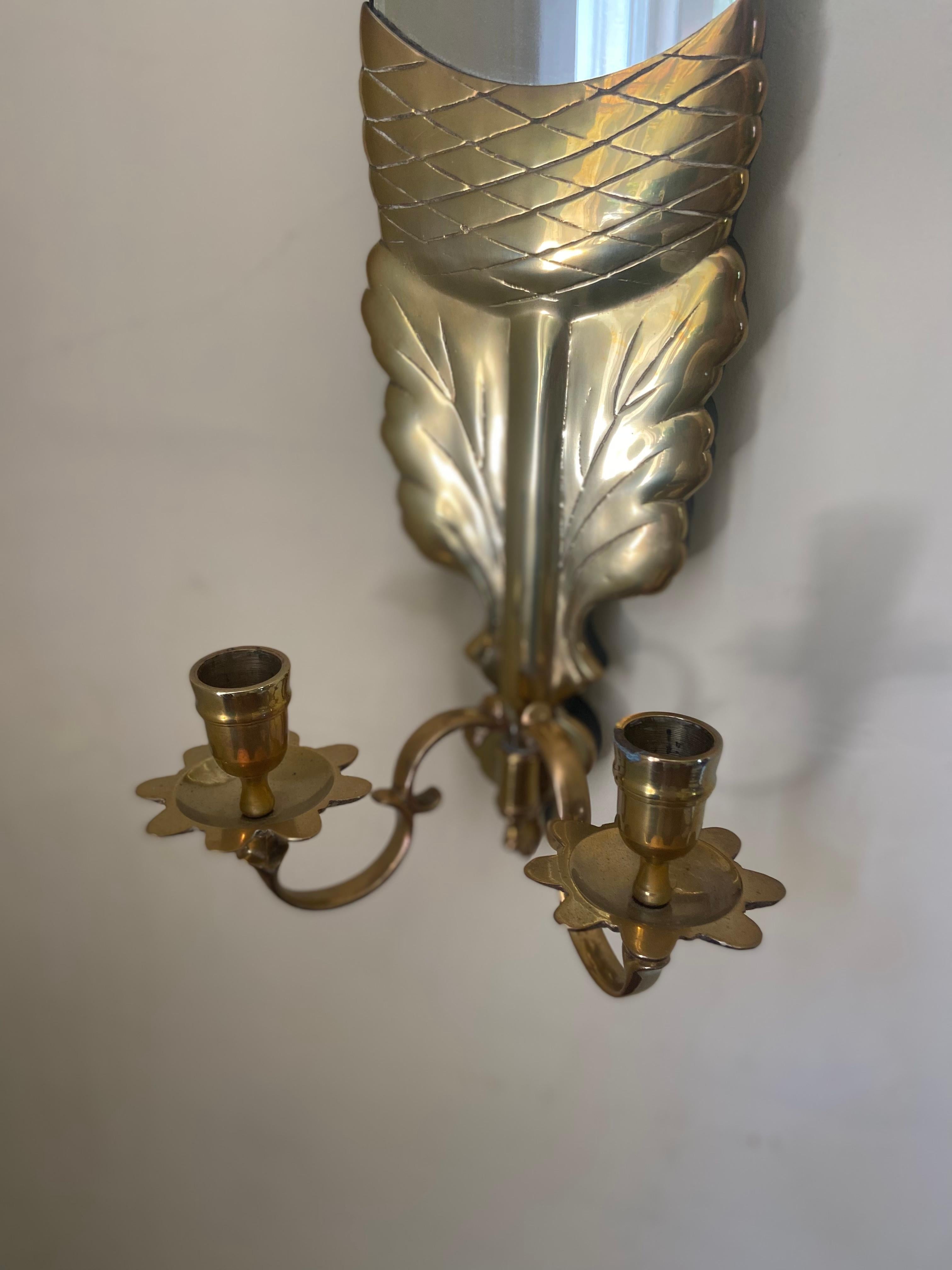 A pair of charming vintage brass and mirrored sconces in the form of a stylized acorn and oak leaf with 2 scrolled candlestick arms by Chapman. 