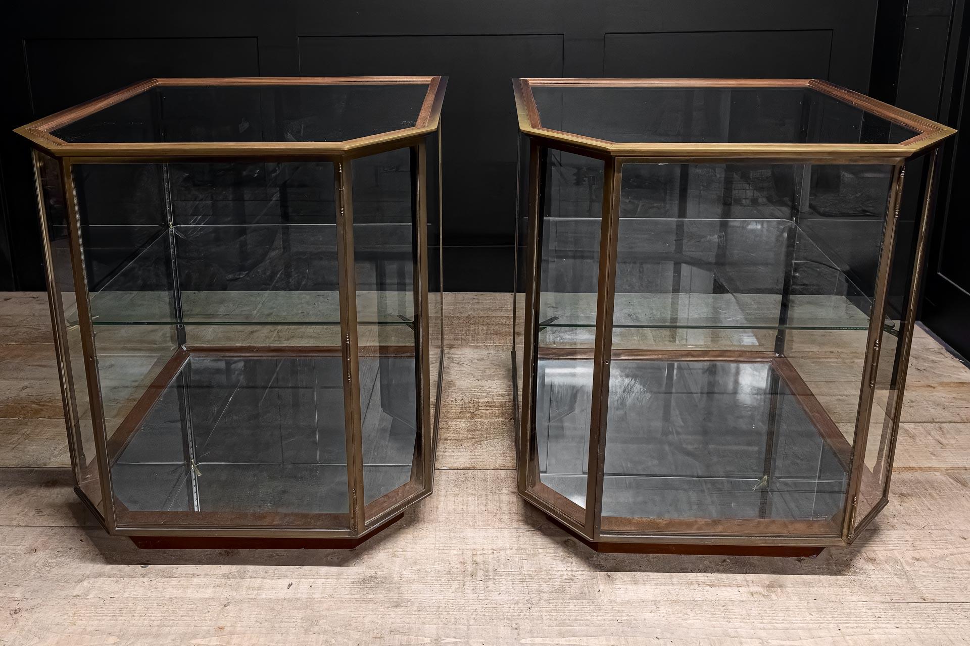Wonderfully rare survivors of the retail display era of the 1920's. This pair of vintage mitre cornered display cabinets offers 360 degree glazing giving the perfect vista from all angles with hinged door on each. Came form a jewellers originally
