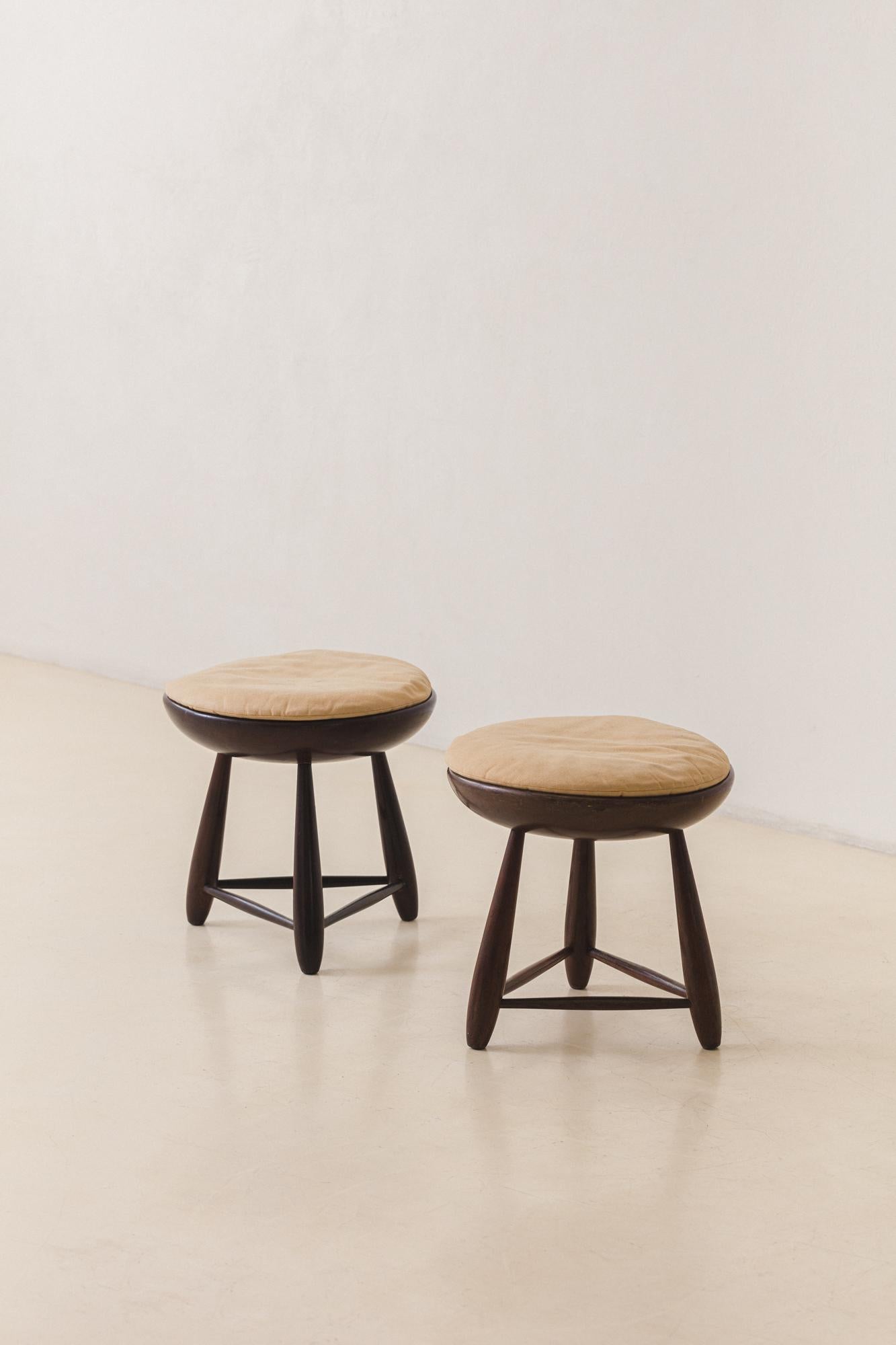 The Mocho stool is one of the most iconic pieces designed by Sergio Rodrigues in 1954, before founding the Oca store. This pair is made of gorgeous solid Rosewood in very good vintage condition with its original cushions. 

As a free