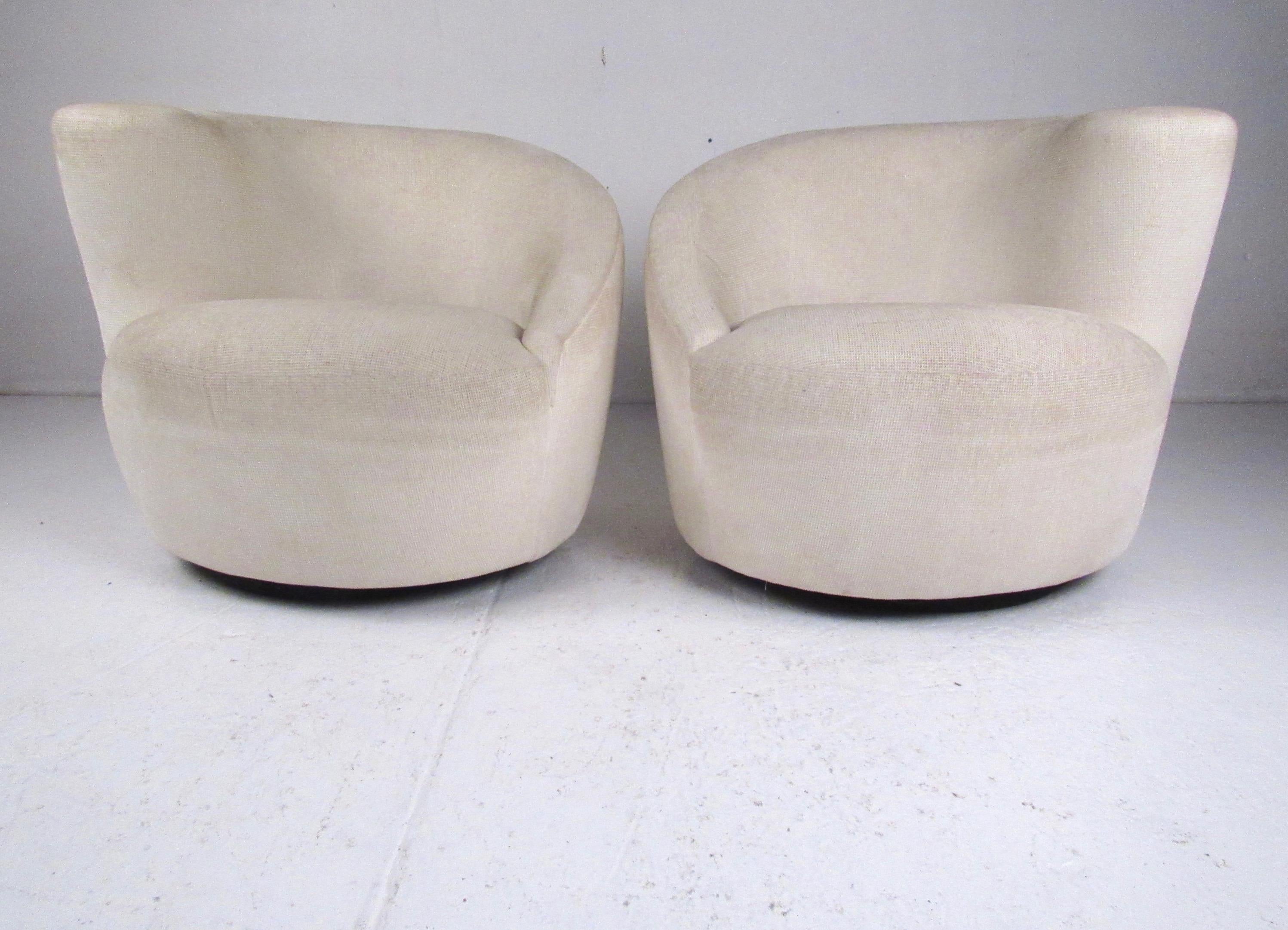 This beautiful pair of vintage modern swivel club chairs feature unique mid-century style corkscrew design, comfortable upholstered seats, and off white fabric. The sculpted seat backs on the vintage pair adds elegant style to home or business