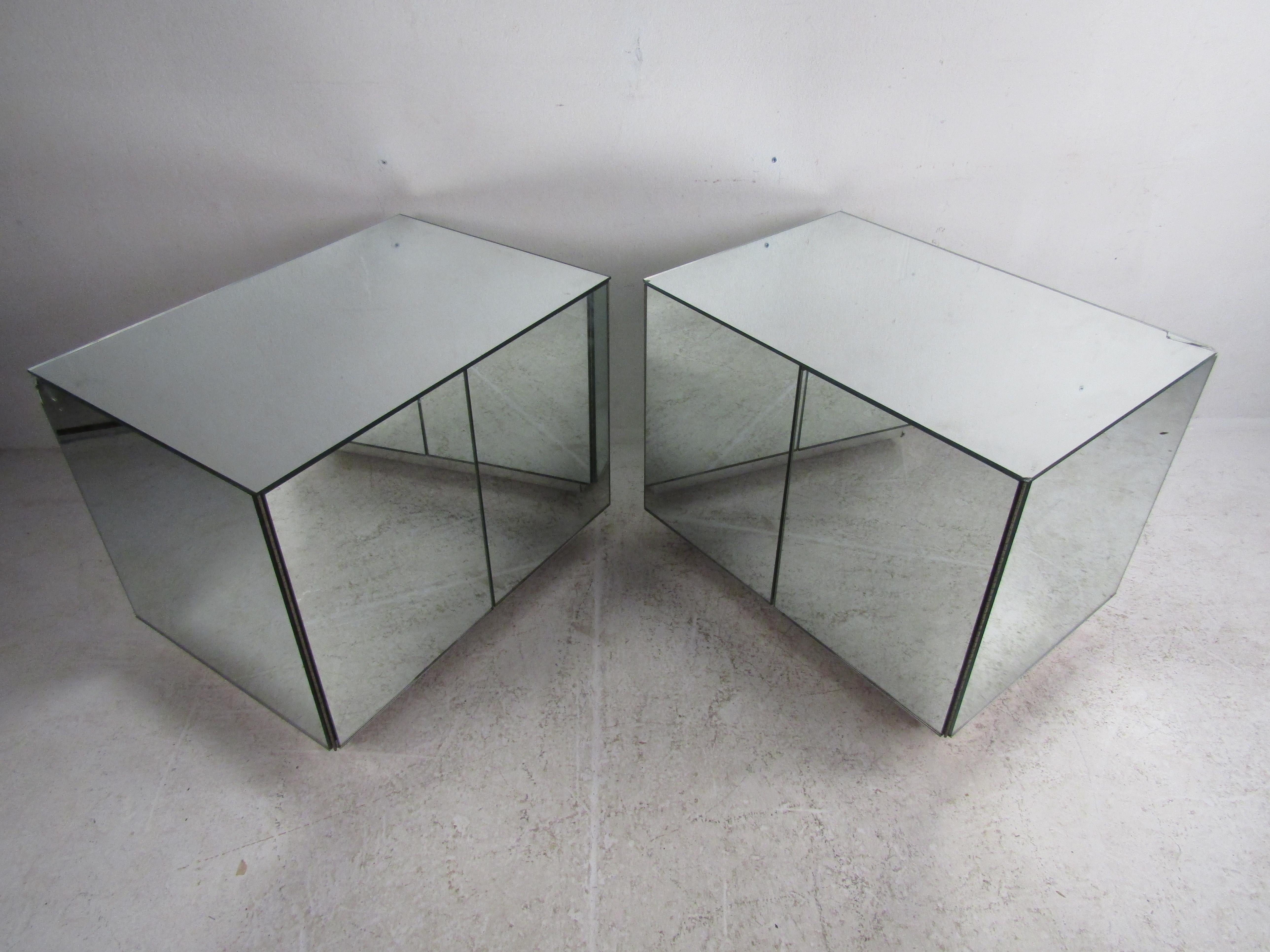 This stunning pair of vintage mirrored cabinets featuring push to open doors revealing ample storage. These unique pieces have multiple sliding drawers along with one adjustable shelf. The mirror finish adds a beautiful touch to this truly hard to