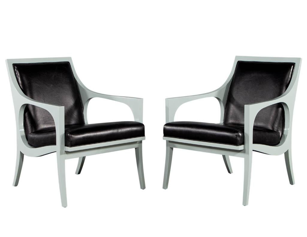 Pair of vintage modern styled accent lounge chairs. Masterfully restored by the artisans at Carrocel in a soft hand polished mint lacquer finish. Completed with black leather upholstery work. Unique Mid-Century Modern sculpted curve design.
Price
