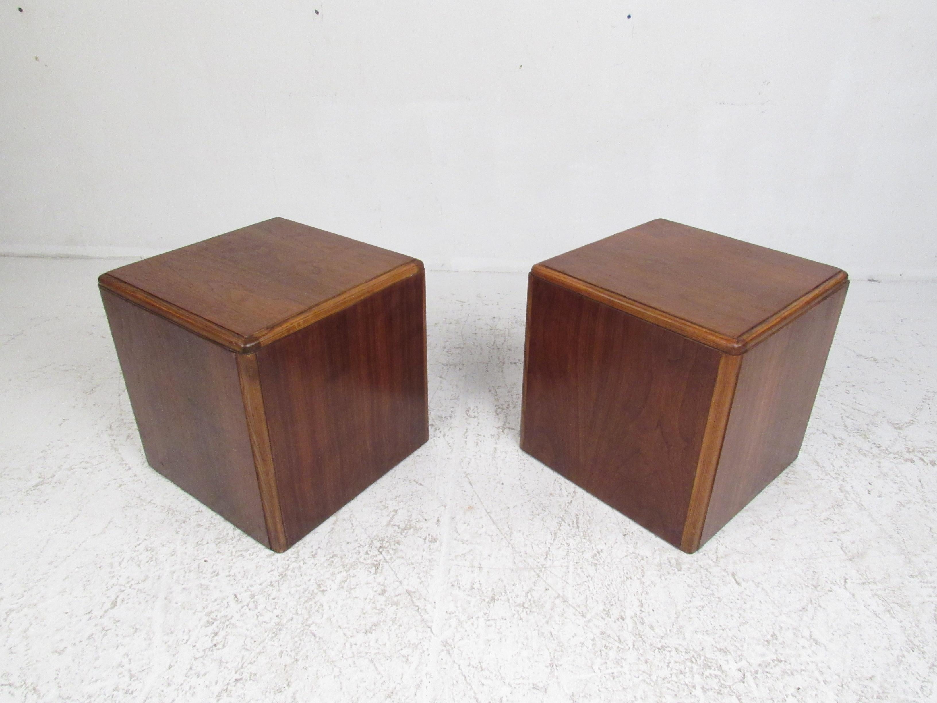 This stylish pair of Mid-Century Modern side tables feature a perfect cubed shape with a vintage walnut finish. This simple, yet sleek pair of tables boast a two-tone design with oak edges complementing walnut wood grain. A convenient side table