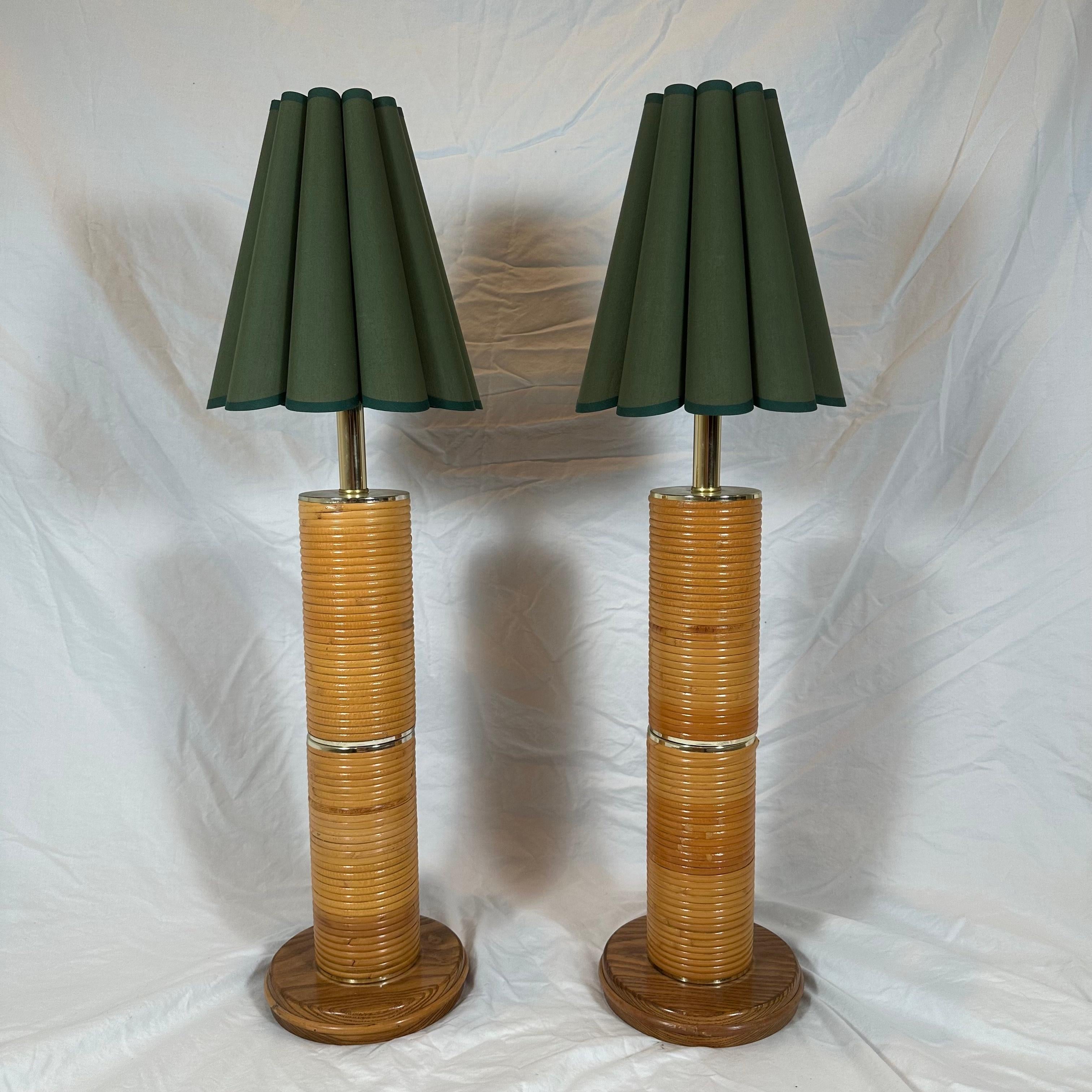 A pair of absolutely monumental, massive pencil reed and brass table lamps. Italian Mid-Century style inspired by Gabriella Crespi. Cylindrical, columnar in form, ringed by ribbed, horizontal bands of split reed bamboo with brass accents. Custom
