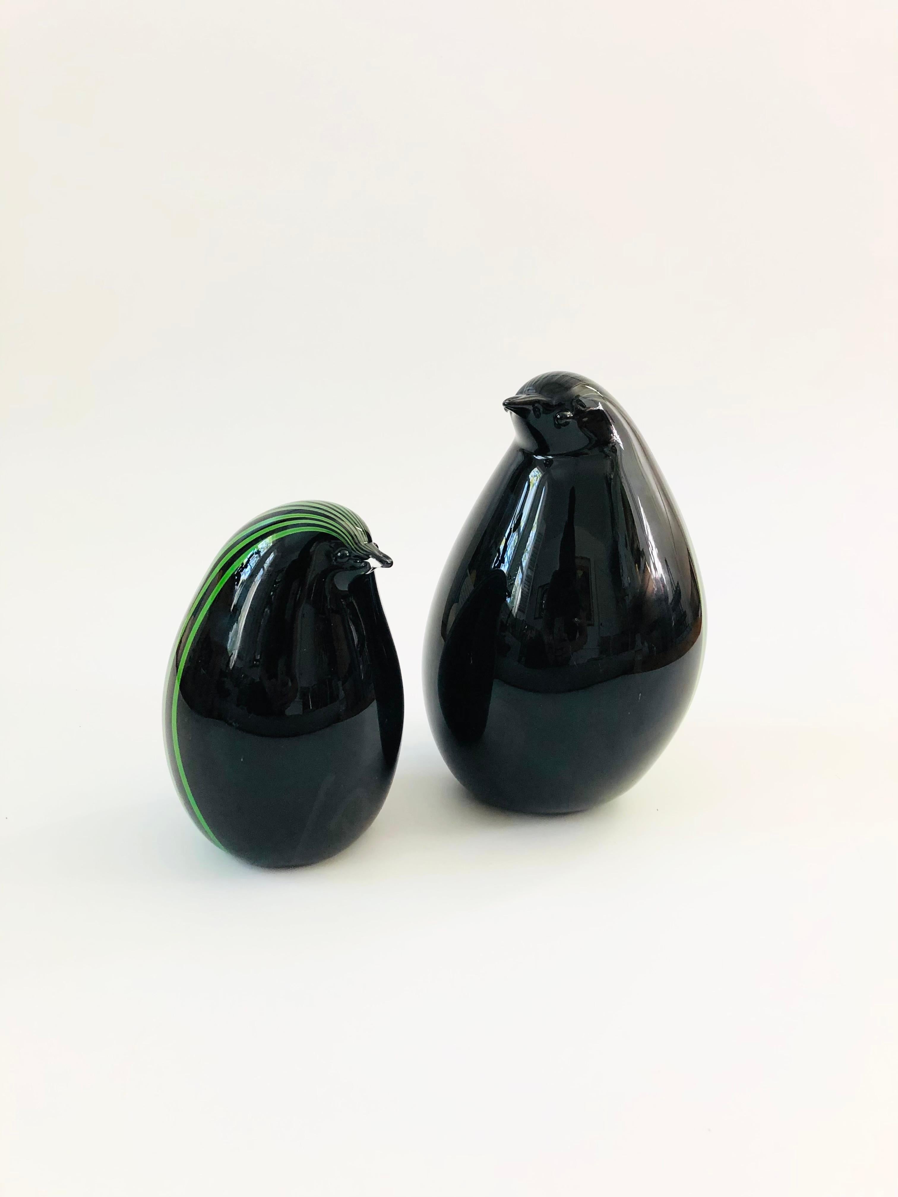 A set of 2 beautiful art glass penguins made by Livio Seguso for Murano. Beautiful vibrant green stripes to the back of each penguin encased in black glass. Nice rounded shapes, no signature, though the form is known to be by Livio Seguso estimated
