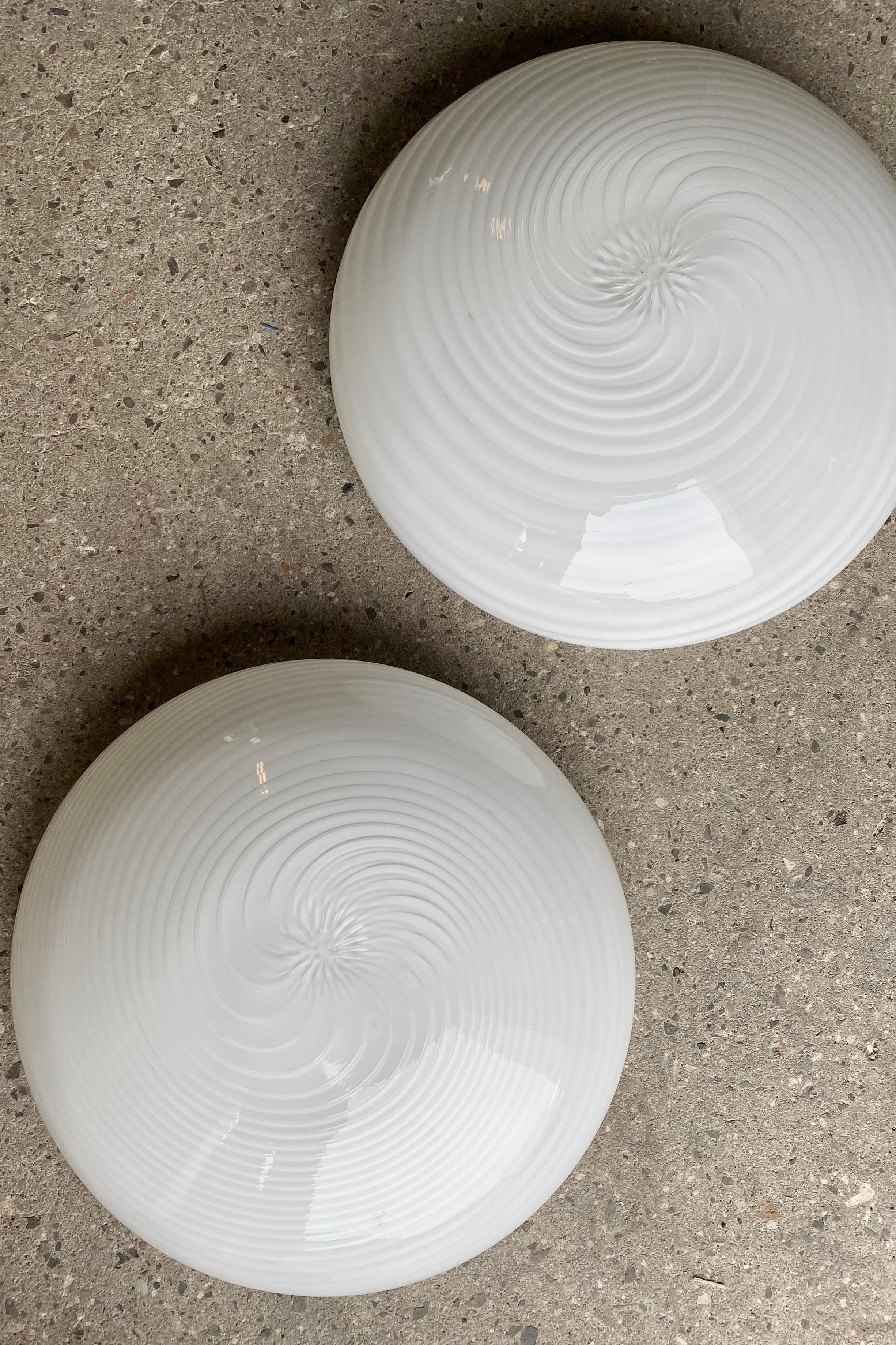 Pair of Murano plafond ceiling lamp / wall lamp. Mouth-blown white opal glass with swirl and white base. E27 socket. Handmade in Italy, 1970s. Original labels. 
D:38 cm⁠⁠ H:14 cm