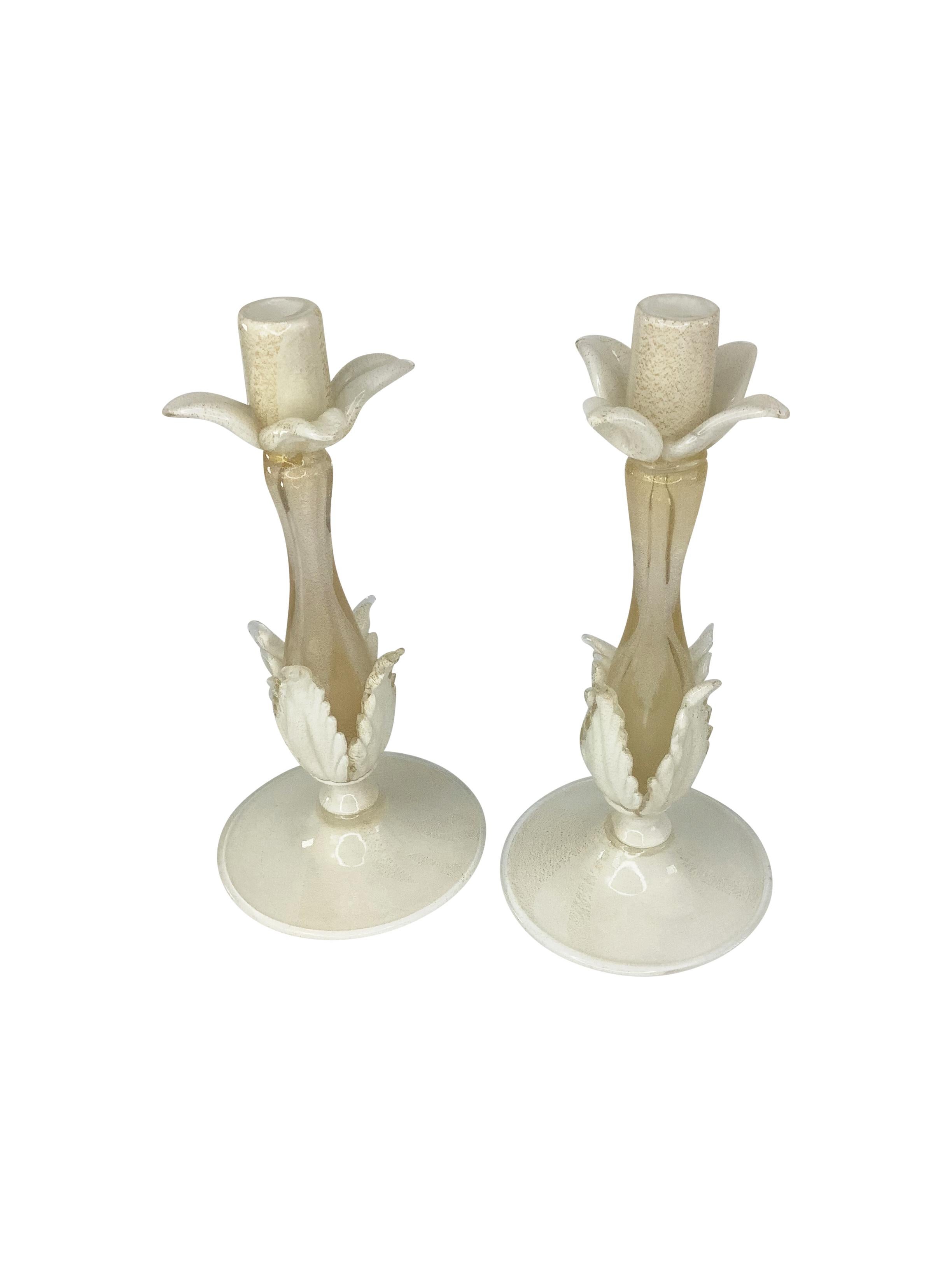 Rare pair of petal-form white and gold Candlesticks attributed to Barovier & Toso Murano Glass. The white foot accented with gold flake issuing a petal form gold stem.
