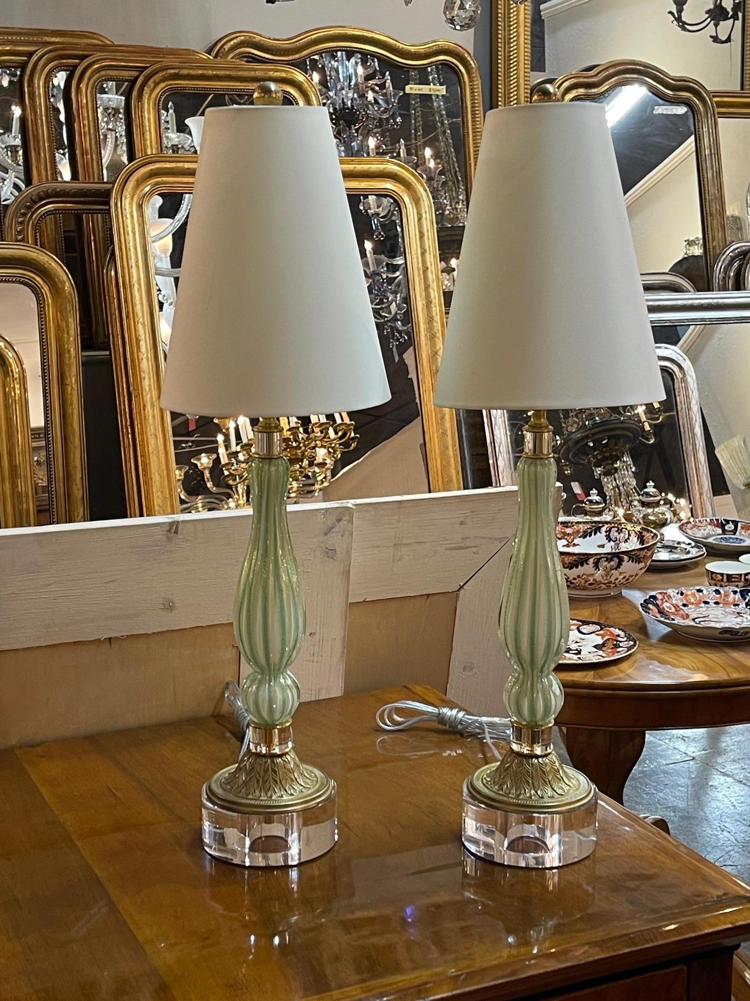 Great pair of vintage Murano glass mint and gold lamps. They are on a lucite and bronze base. These lamps have great lines and style. Sure to make a statement.