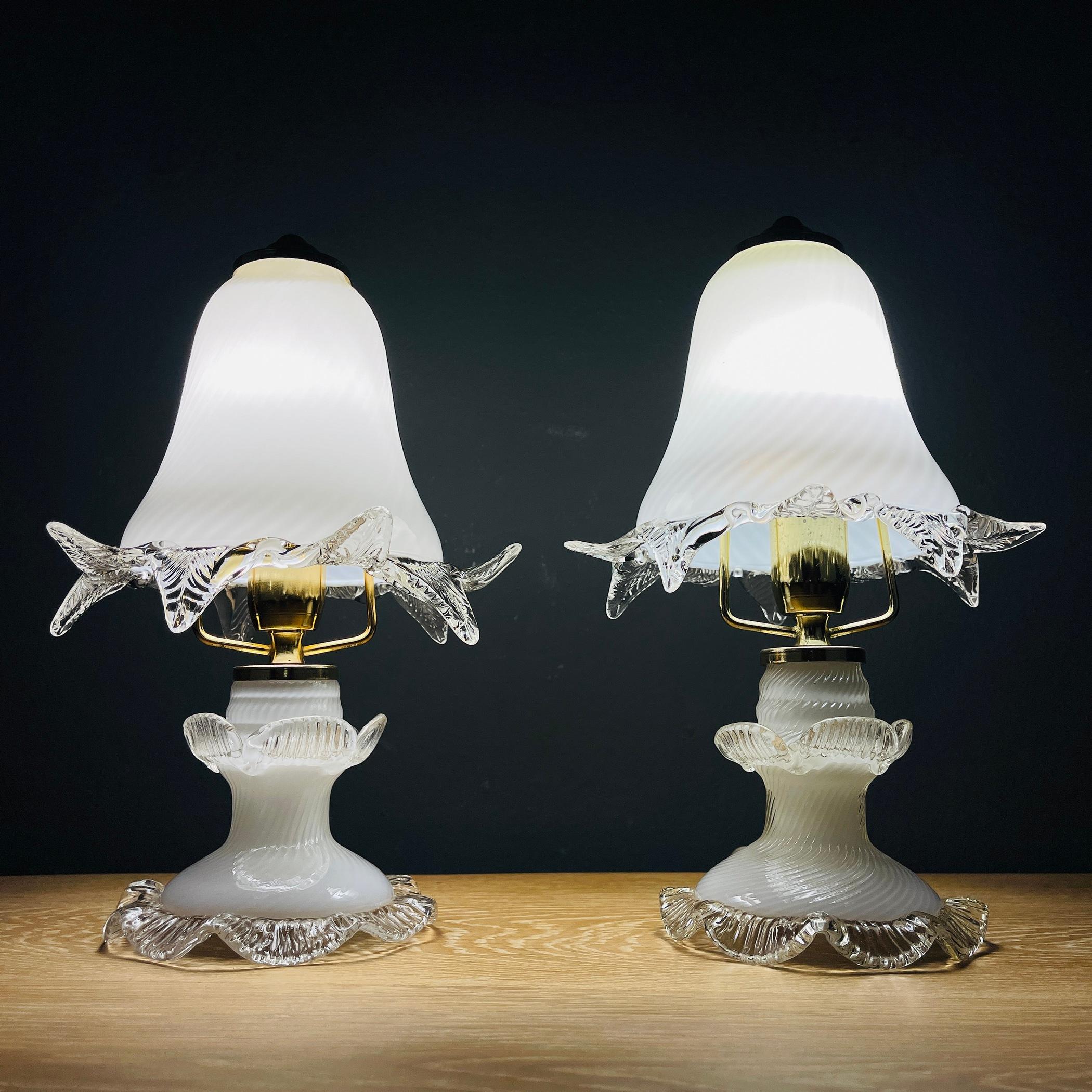 Enchant your home with this exquisite pair of Murano glass night lights, handcrafted in Italy during the 1980s. These captivating pieces are sure to adorn your space with timeless elegance. Rest assured, these night lights are in very good vintage