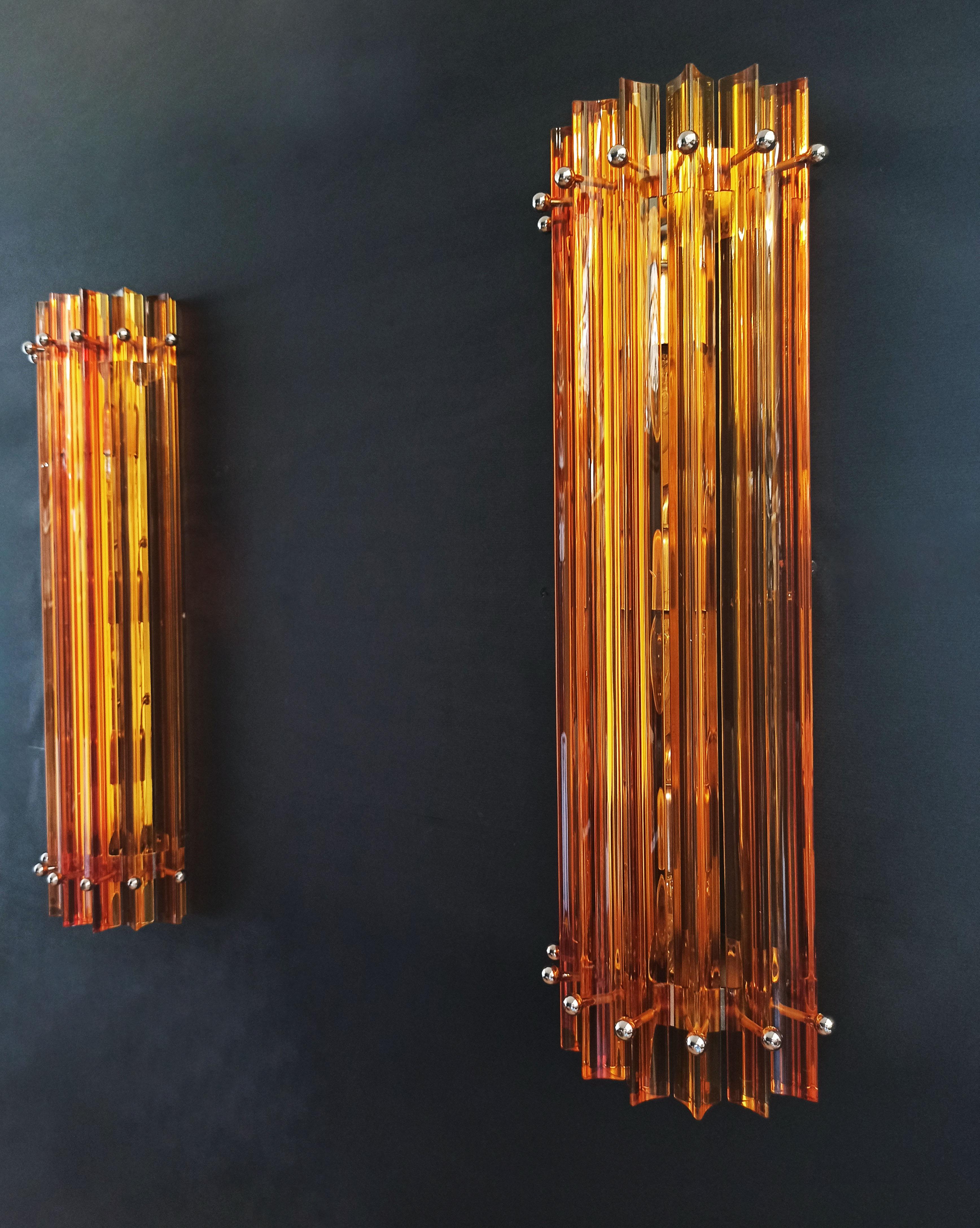 Fantastic pair of vintage Murano wall sconce made by 7 Murano crystal prism (triedri) for each applique in a chrome metal frame. The shape of this sconce is column. The glasses are amber. The wall lamps can be installed vertically, as photos, very
