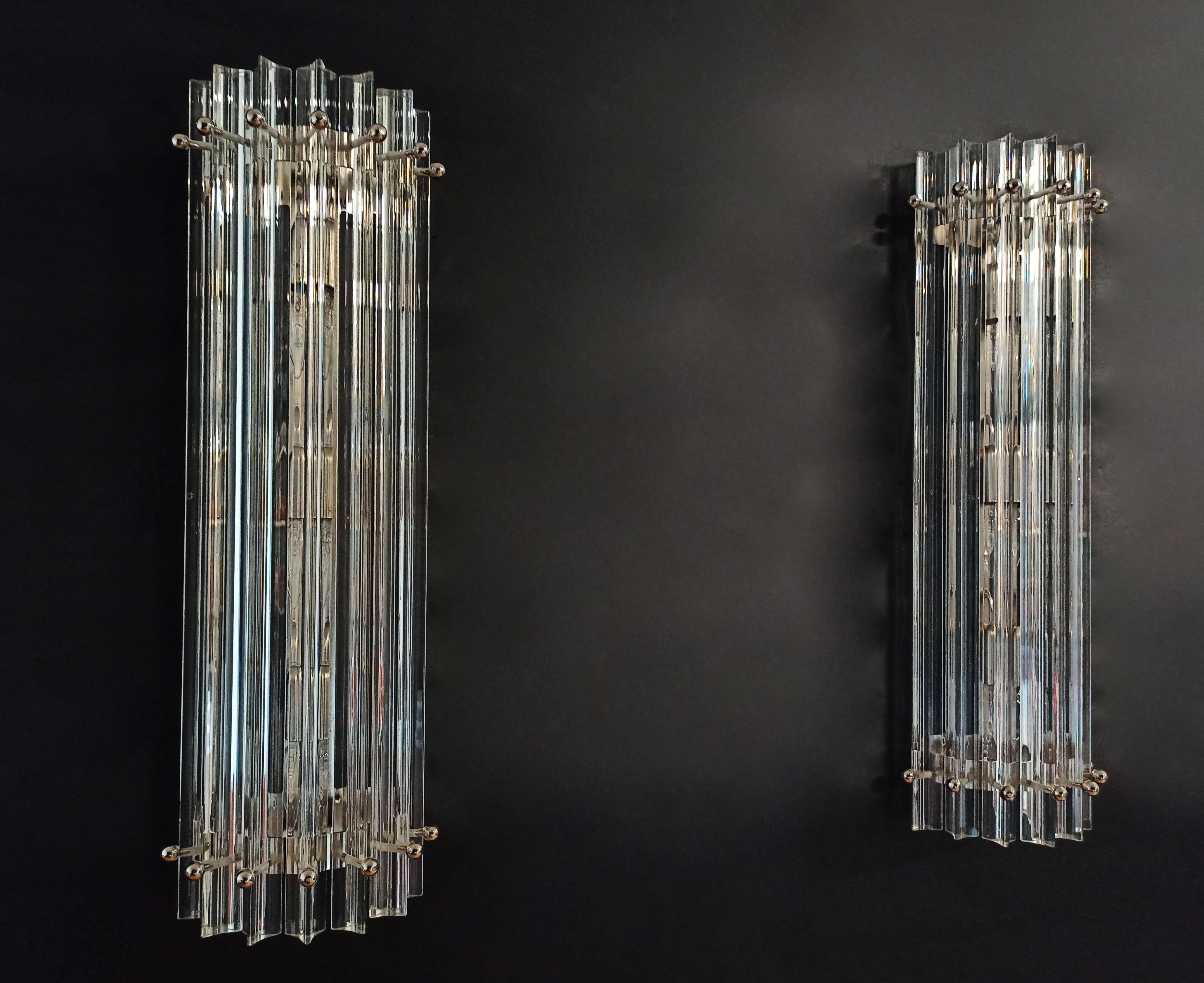 Fantastic pair of Murano wall sconce made by 7 Murano crystal prism (triedri) for each applique in a chrome metal frame. The shape of this sconce is column. The glasses are transparent. The wall lamps can be installed vertically, as photos, very