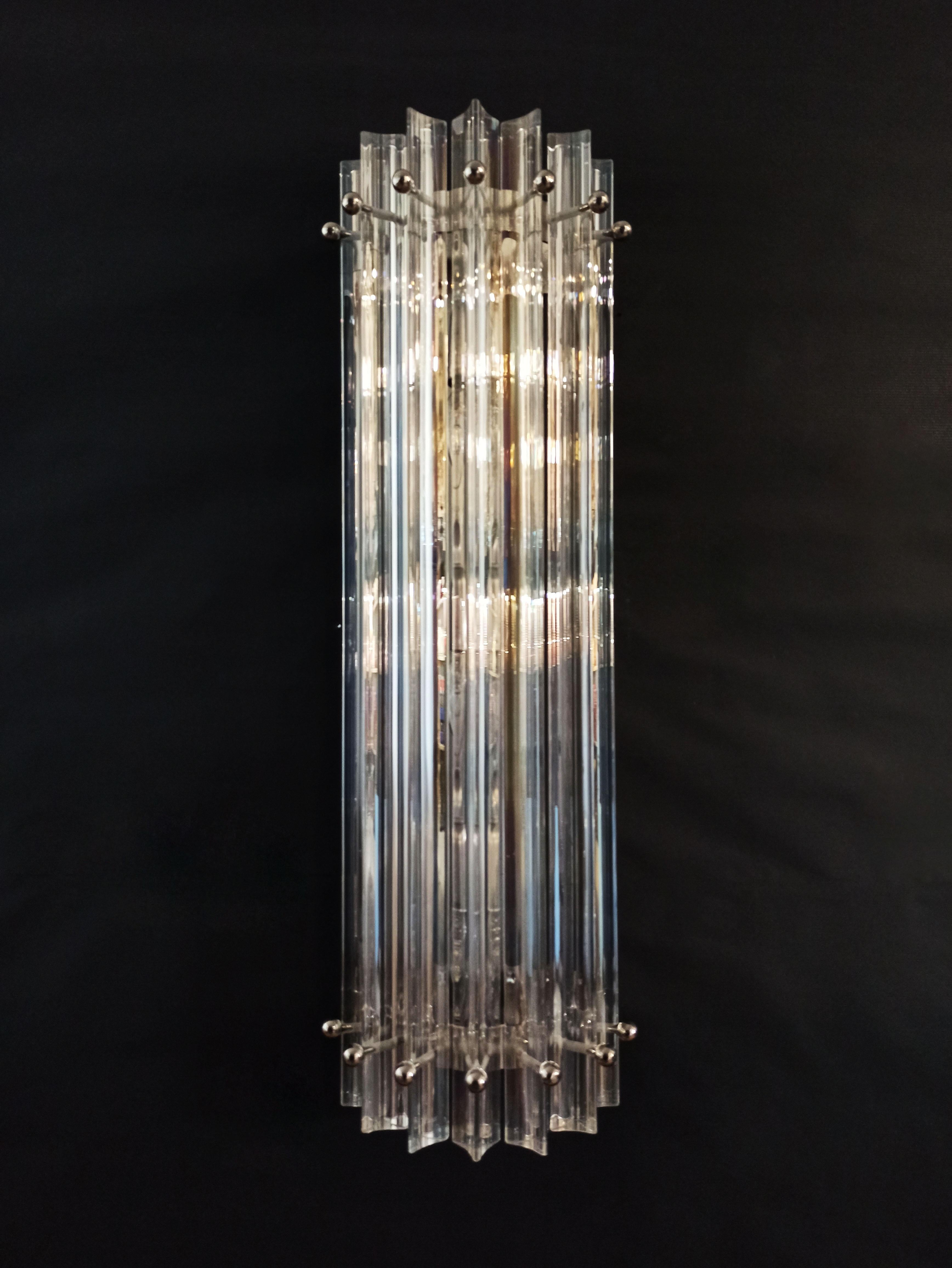Fantastic pair of vintage Murano wall sconce made by 7 Murano iridescent prism (triedri) for each applique in a chrome metal frame. The shape of this sconce is column. The glasses have the particularity of reflecting a multiplicity of colors, which