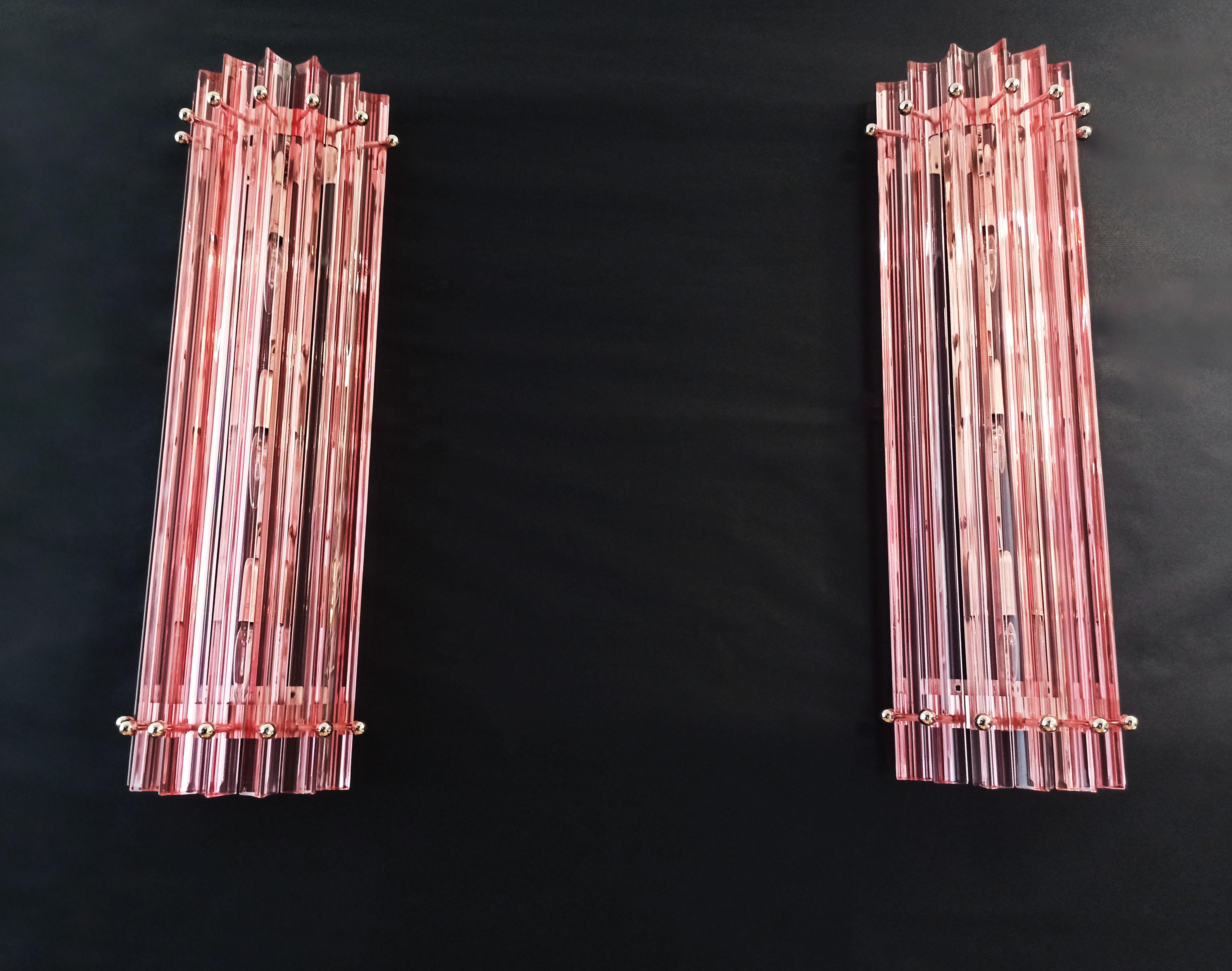 Fantastic pair of vintage Murano wall sconce made by 7 Murano crystal prism (Triedri) for each applique in a chrome metal frame. The shape of this sconce is column. The glasses are pink. The wall lamps can be installed vertically, as photos, very