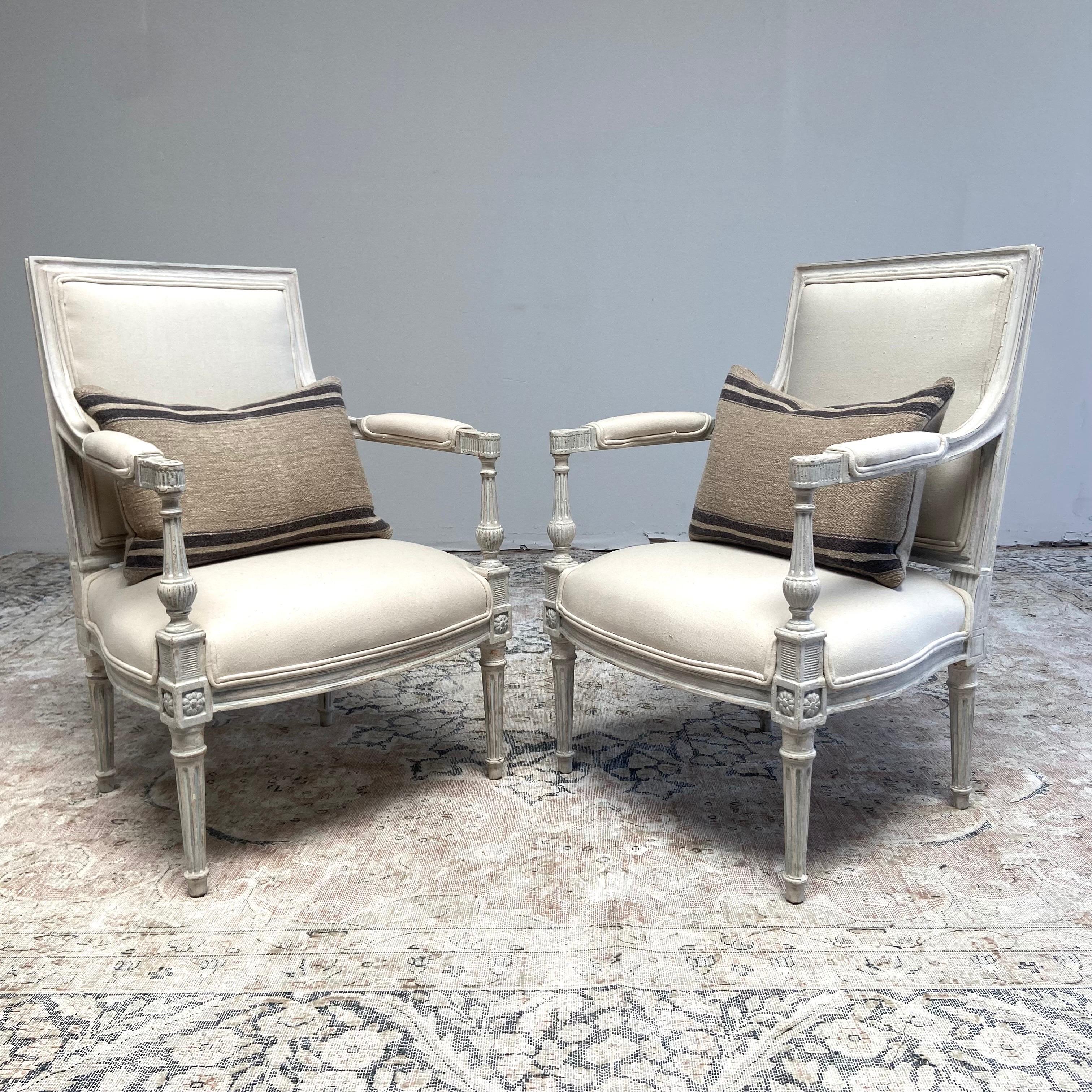 Pair of Vintage Neoclassical Painted and Upholstered Arm Chairs
Painted in a soft oyster white with subtle antique distressed edges, and finished in an antique patina.

Pair arm chairs 24”w x 24”d x 35”h
SH:16”. SD:19”. AH:24”.