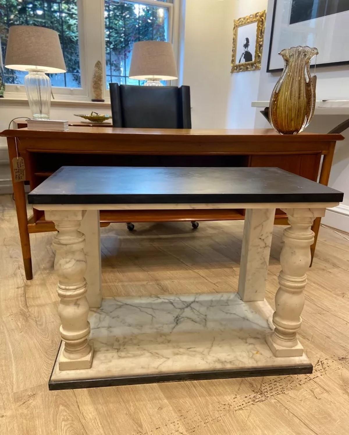 A pair of beautiful rectangular vintage side/ occasional tables. 

These rare tables feature black slate tops with Carrera marble bases with a neoclassical style with the marble coloums featured as the front two legs of each table.  

The elegant