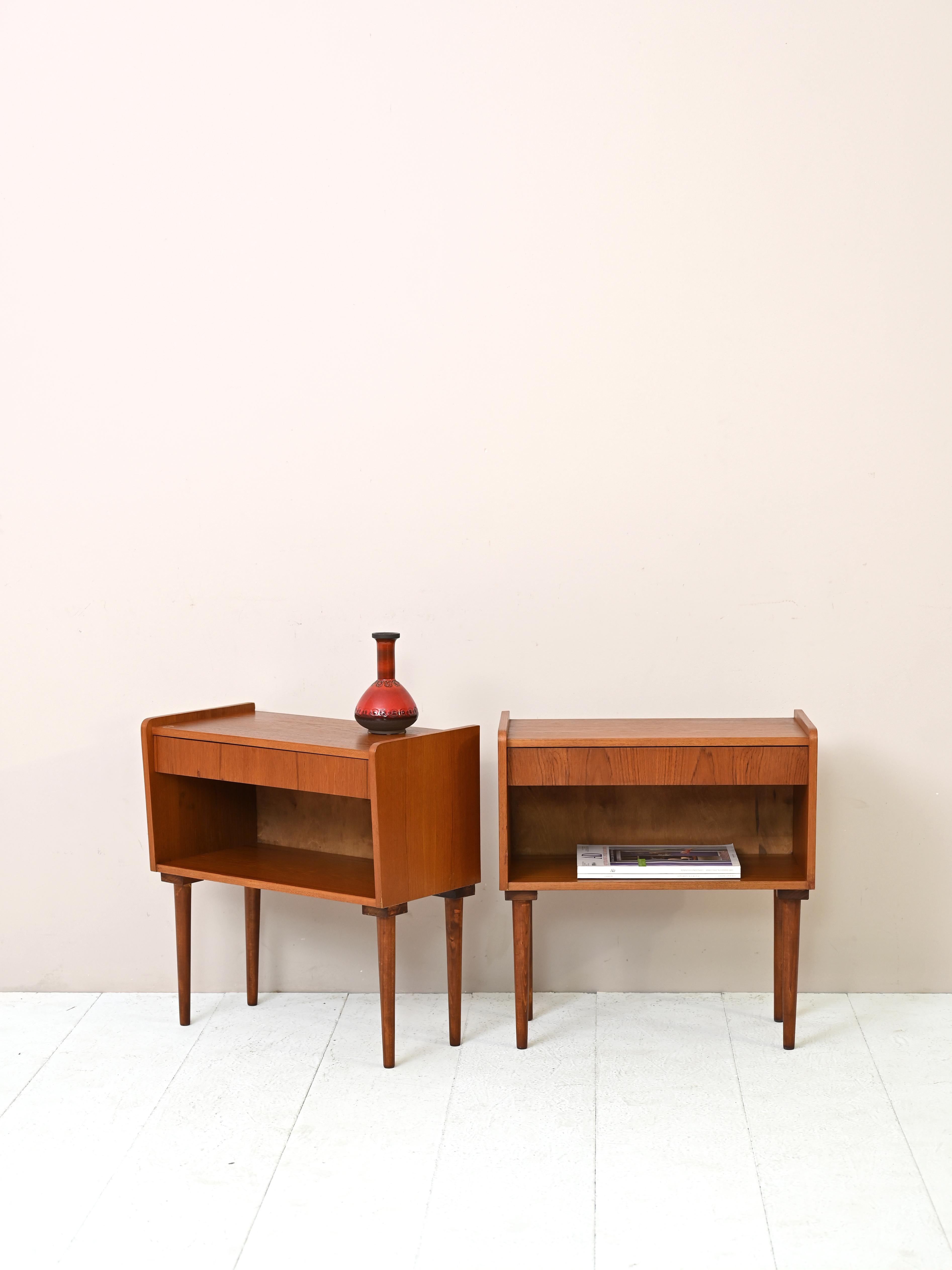 Pair of vintage Scandinavian teak nightstands. 

Regular, tapered lines for these 1950s nightstands with timeless beauty.

Equipped with a drawer and a useful shelf underneath, they will be an essential addition to the bedroom.

Good